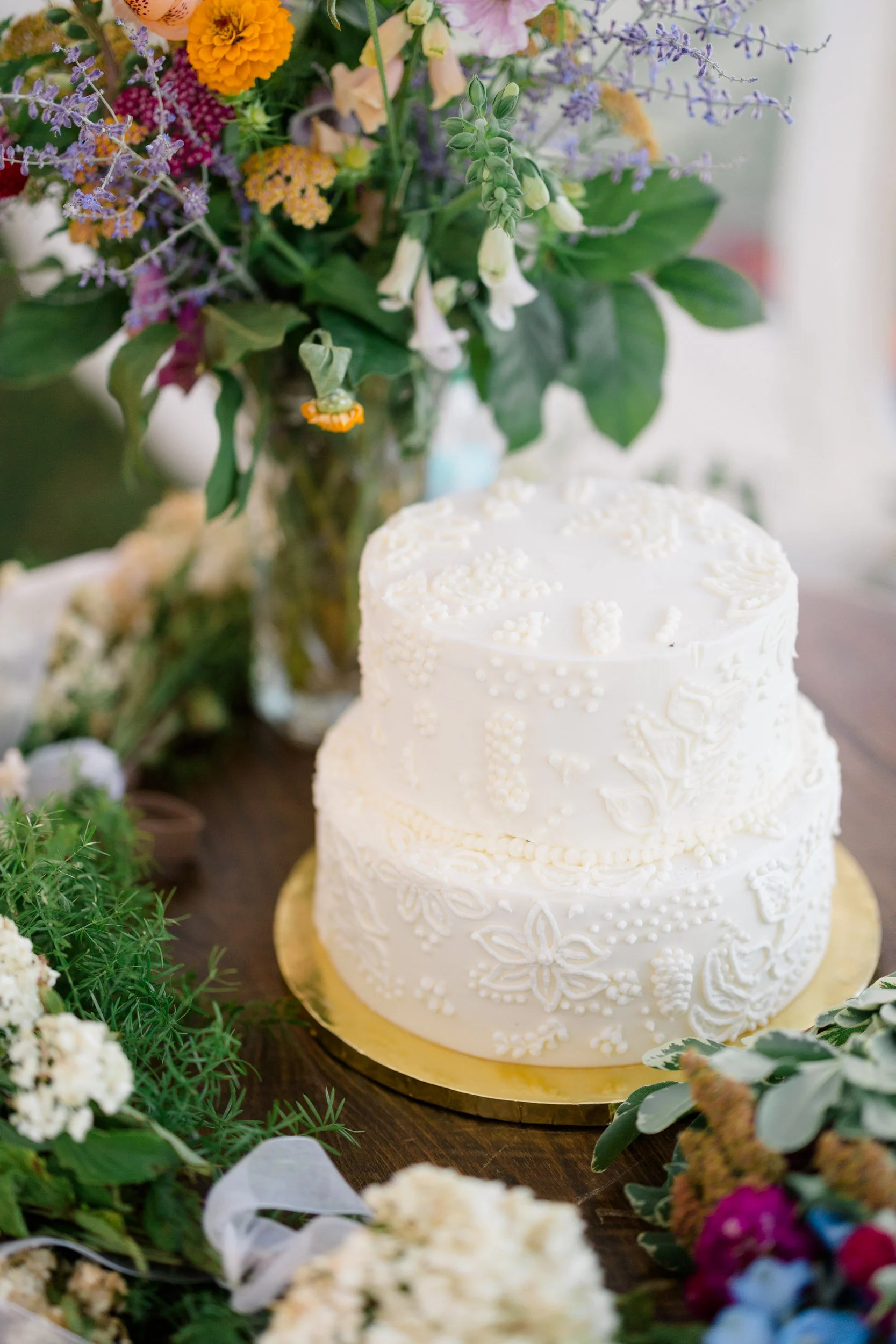 Elegant wedding cake displayed before the cake cutting at a Cape Cod private estate wedding.