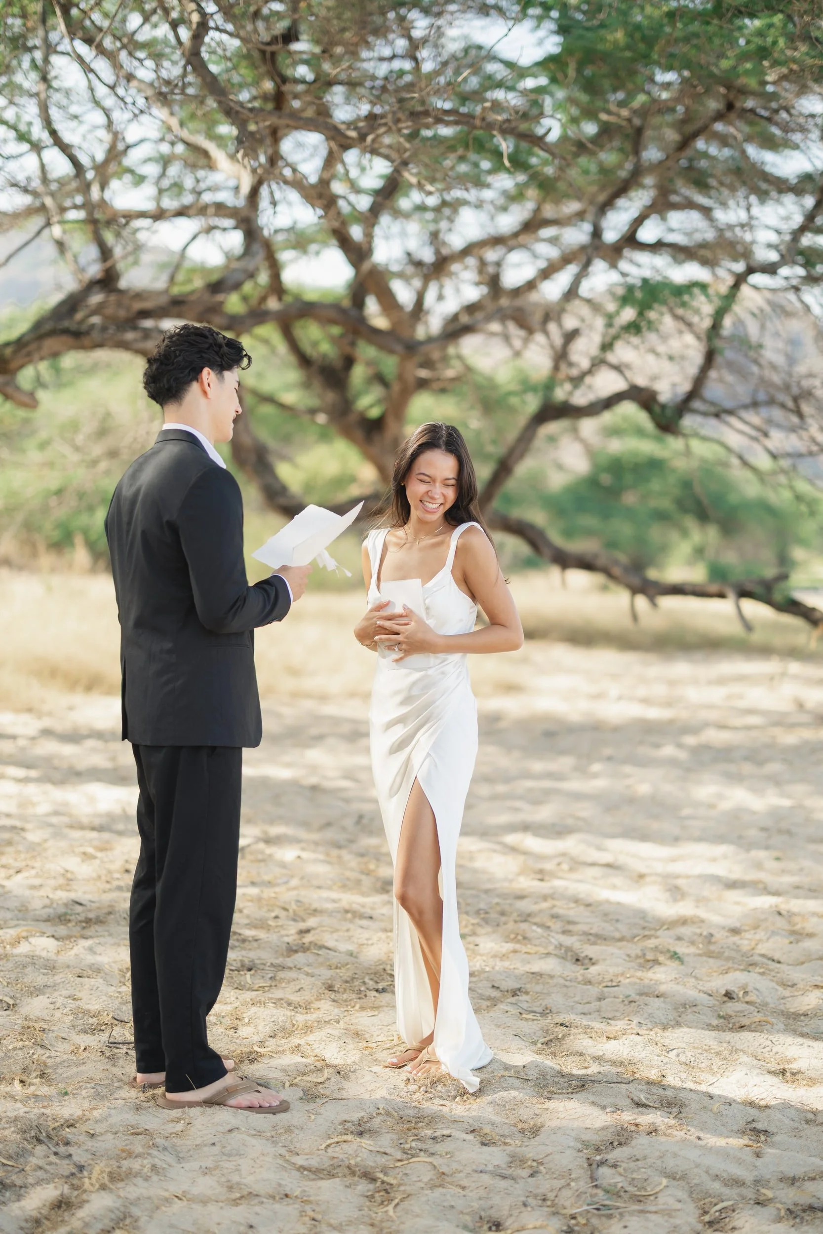 Bride and groom reading vows during Hawaii elopement