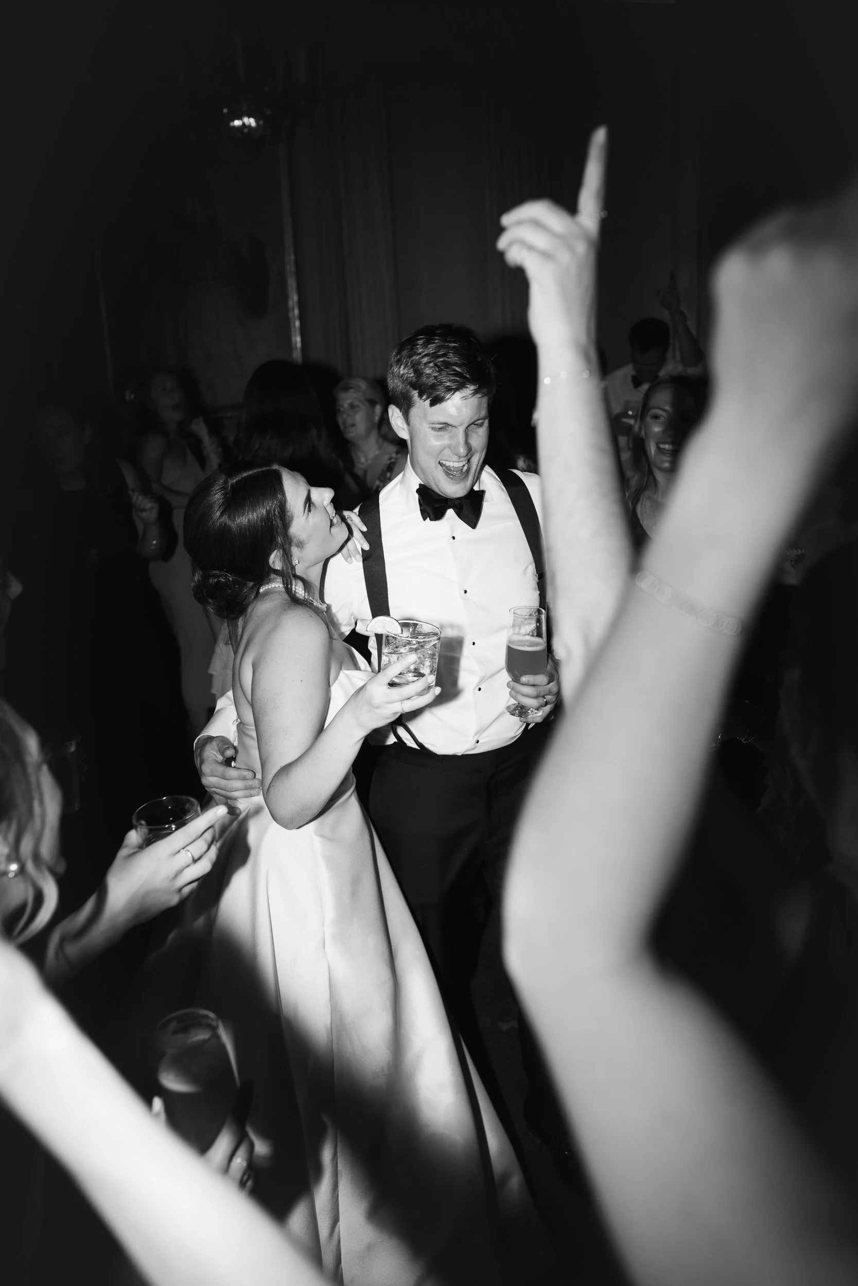 Bride and groom celebrating with guests on the dance floor inside the sailcloth tent at Crane Estate.