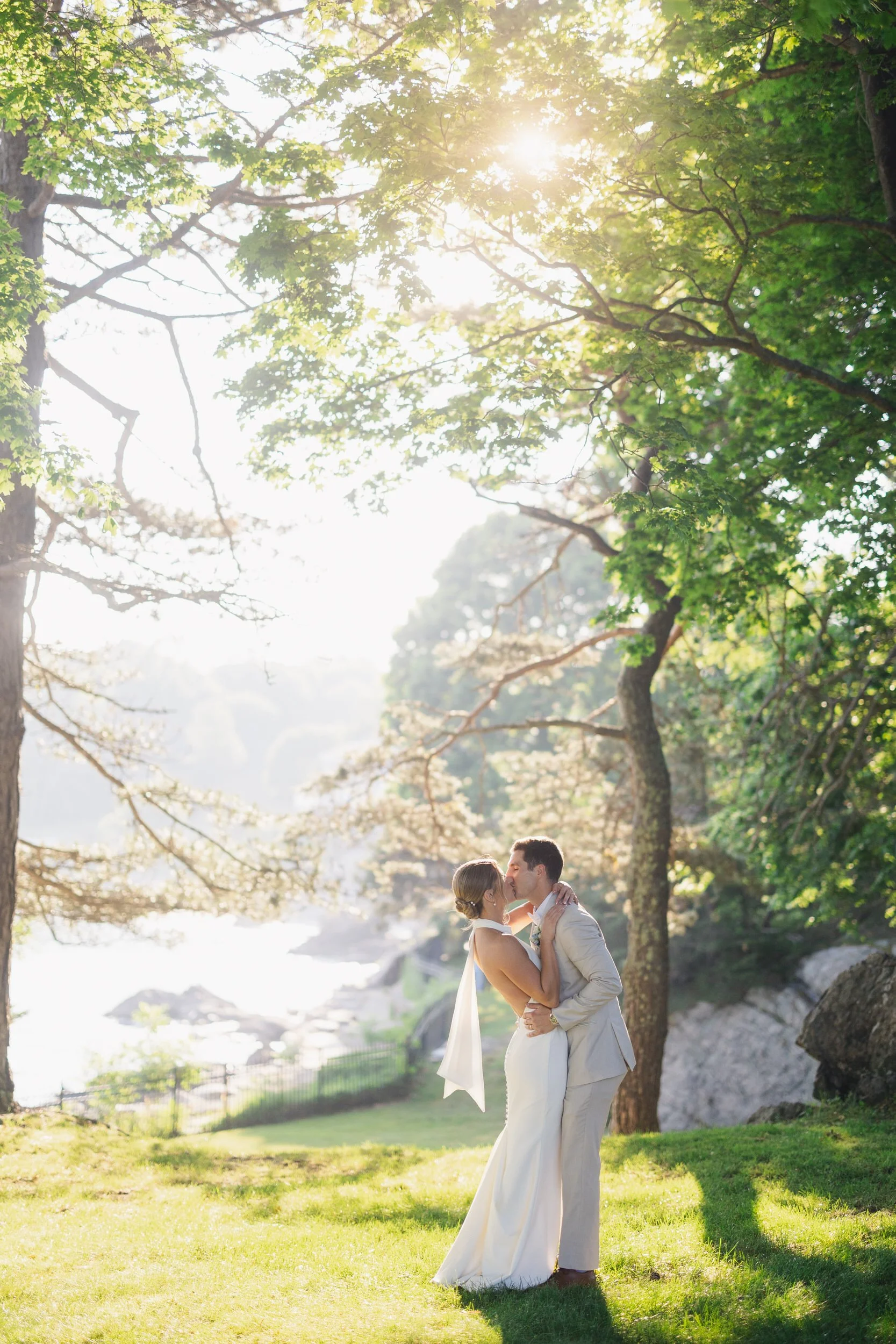 Newlywed couple photographed during sunset on a summer wedding day.