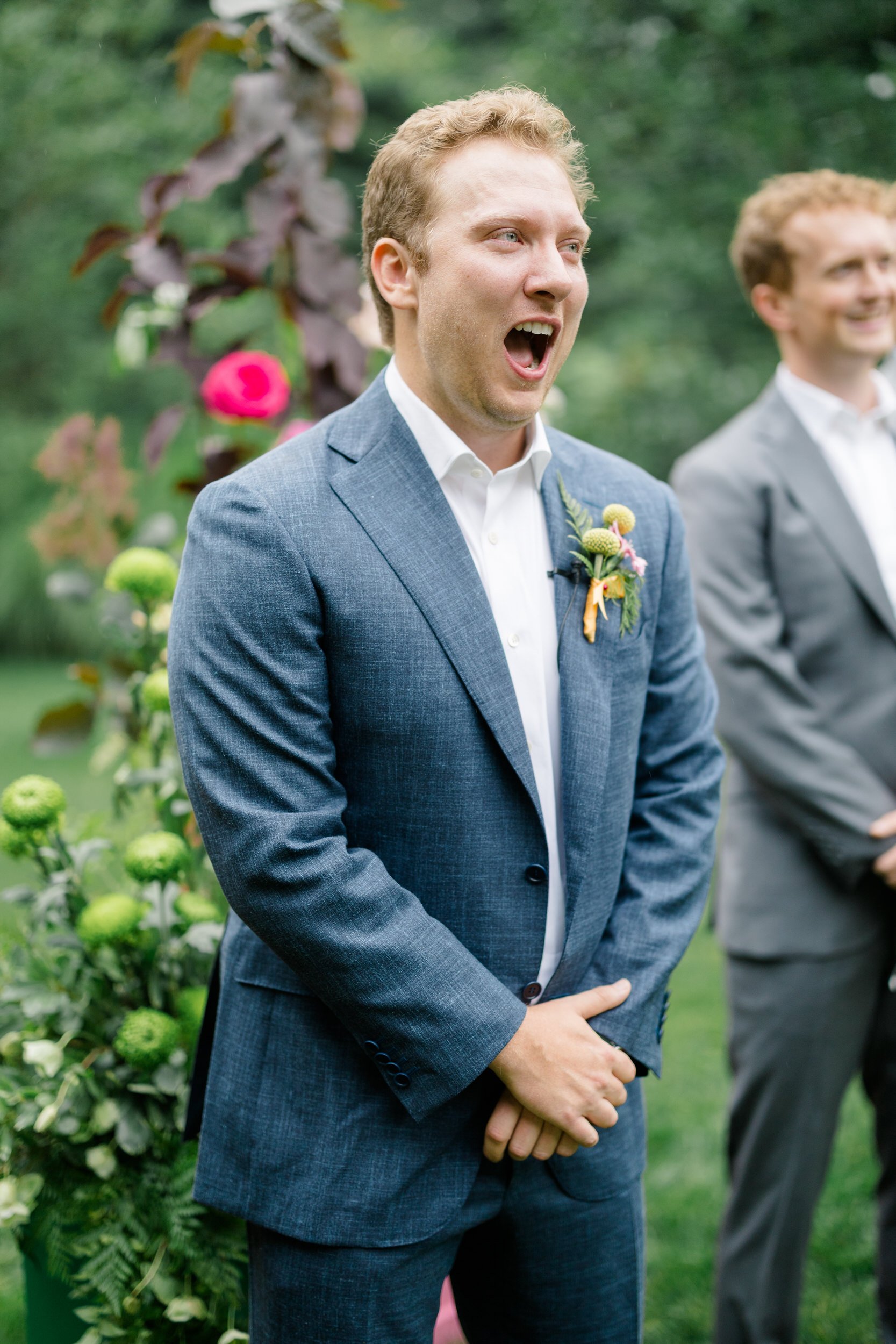 Colorful garden wedding ceremony at the Connors Center surrounded by vibrant seasonal florals.