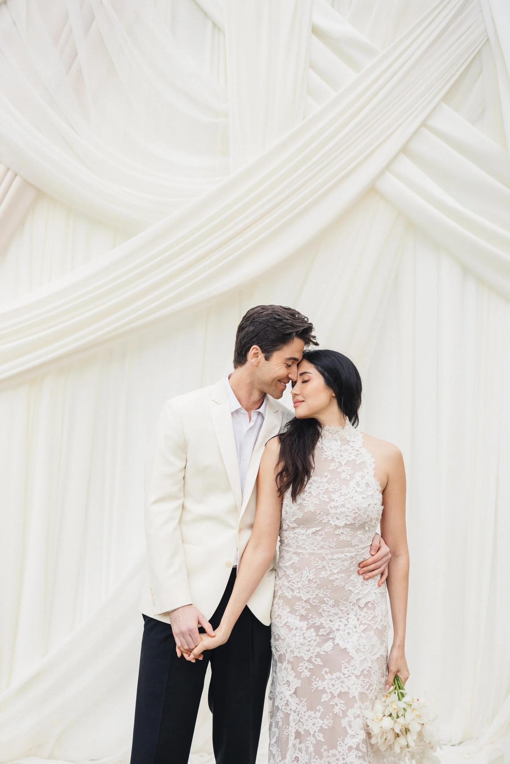 Bride and groom embracing at Lowndes Grove ceremony site in Charleston