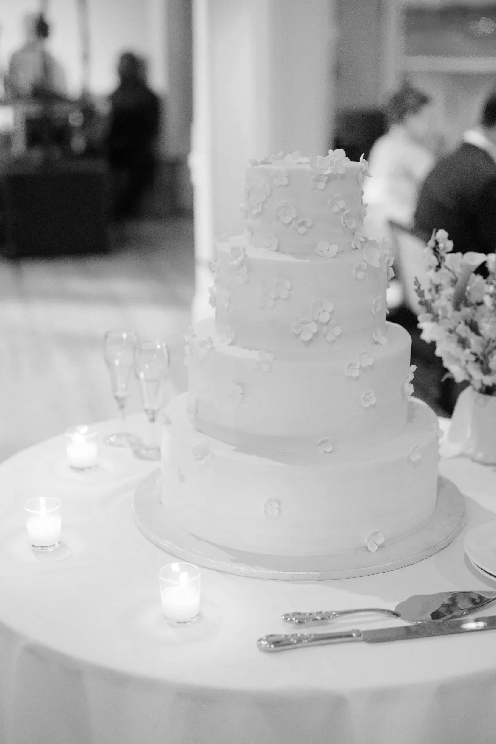 Elegant wedding cake featuring hand-crafted sugar flowers at this Corinthian Yacht Club Marblehead wedding.