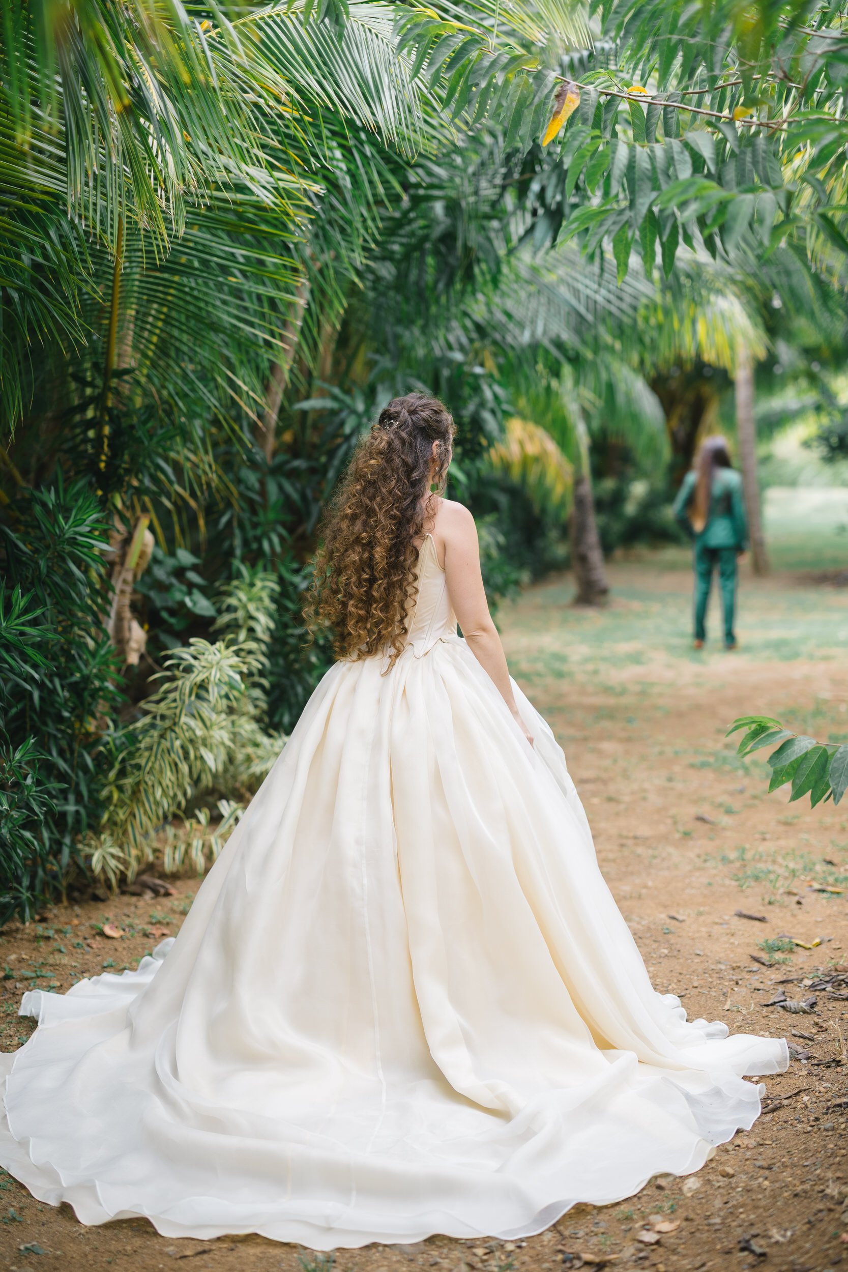 Two brides sharing their first look in a tropical banana grove in St. Thomas.