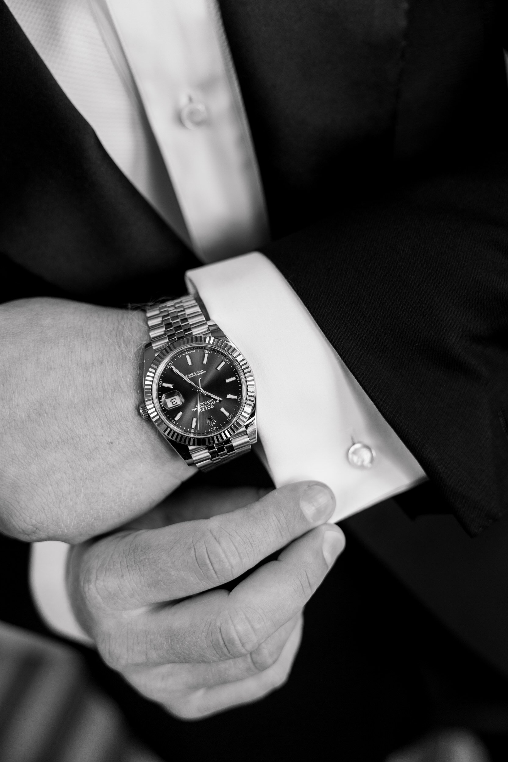 Close-up of the groom's wedding suit and accessories before the ceremony.
