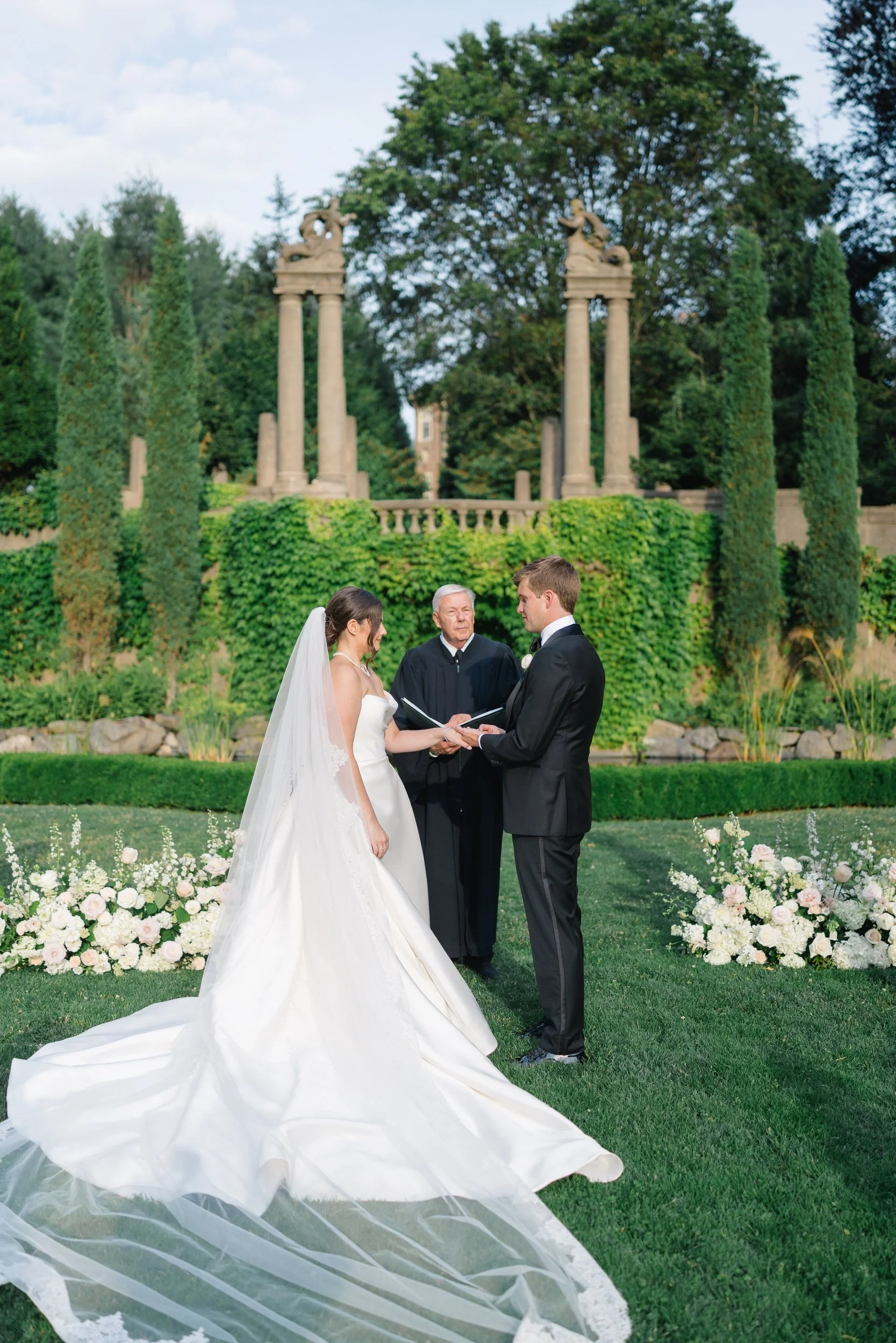 Couple exchanging vows during their outdoor ceremony at Castle Hill on the Crane Estate.