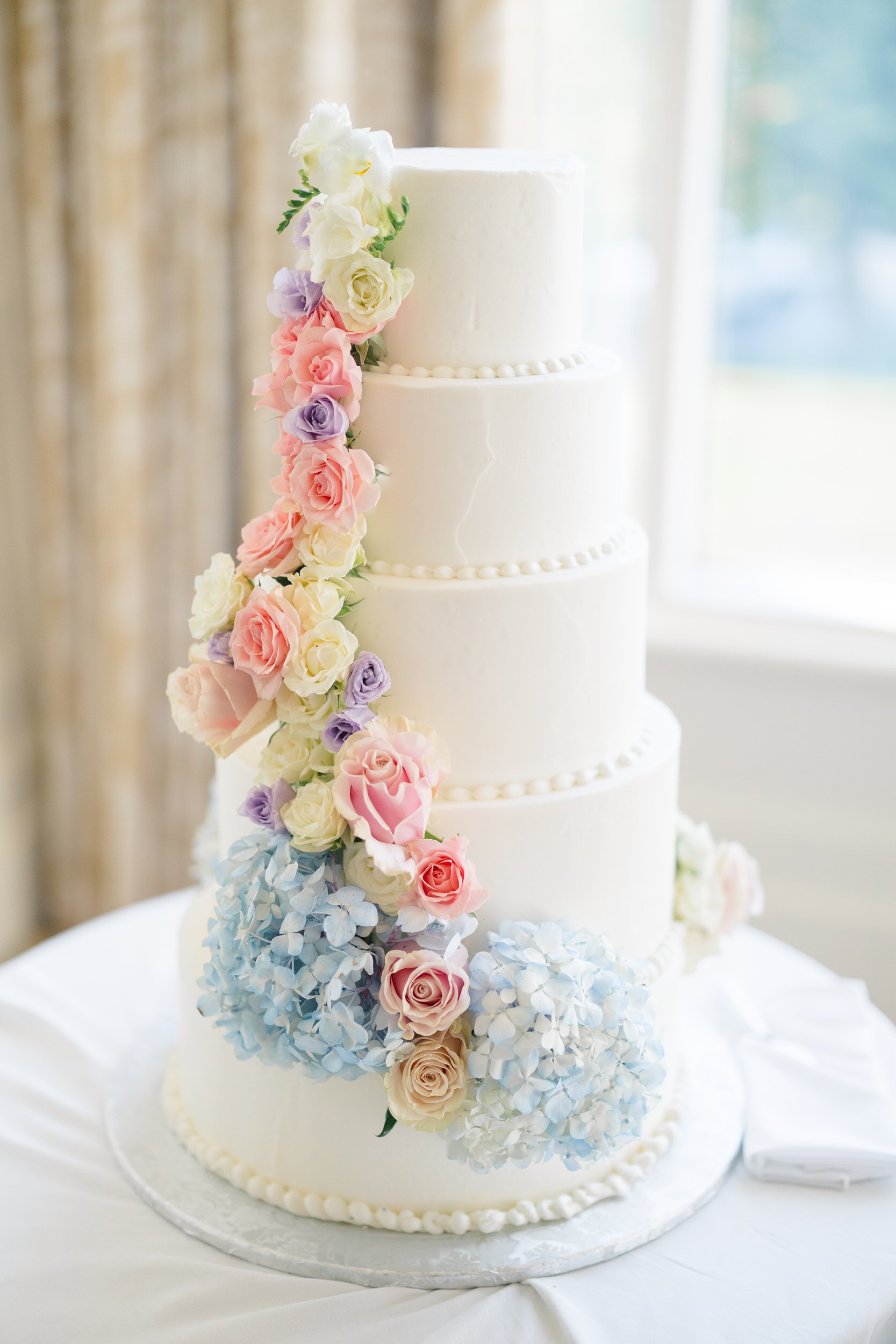 Bride and groom cutting their wedding cake at Ocean Edge Resort