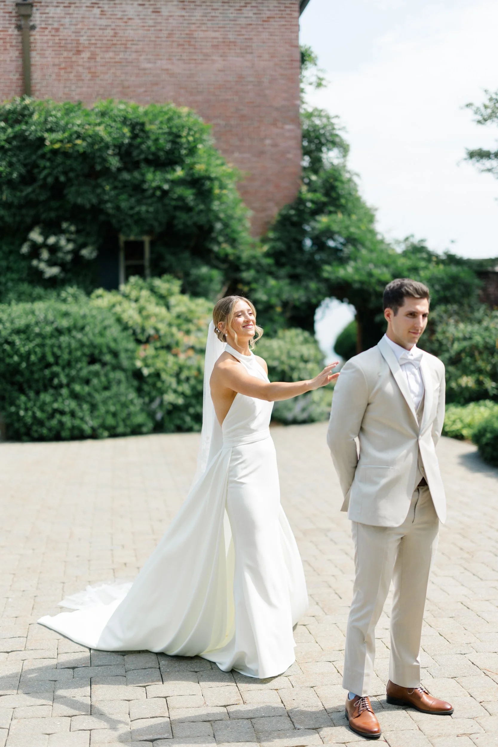 Emotional first look between the couple on a sunny summer wedding day.