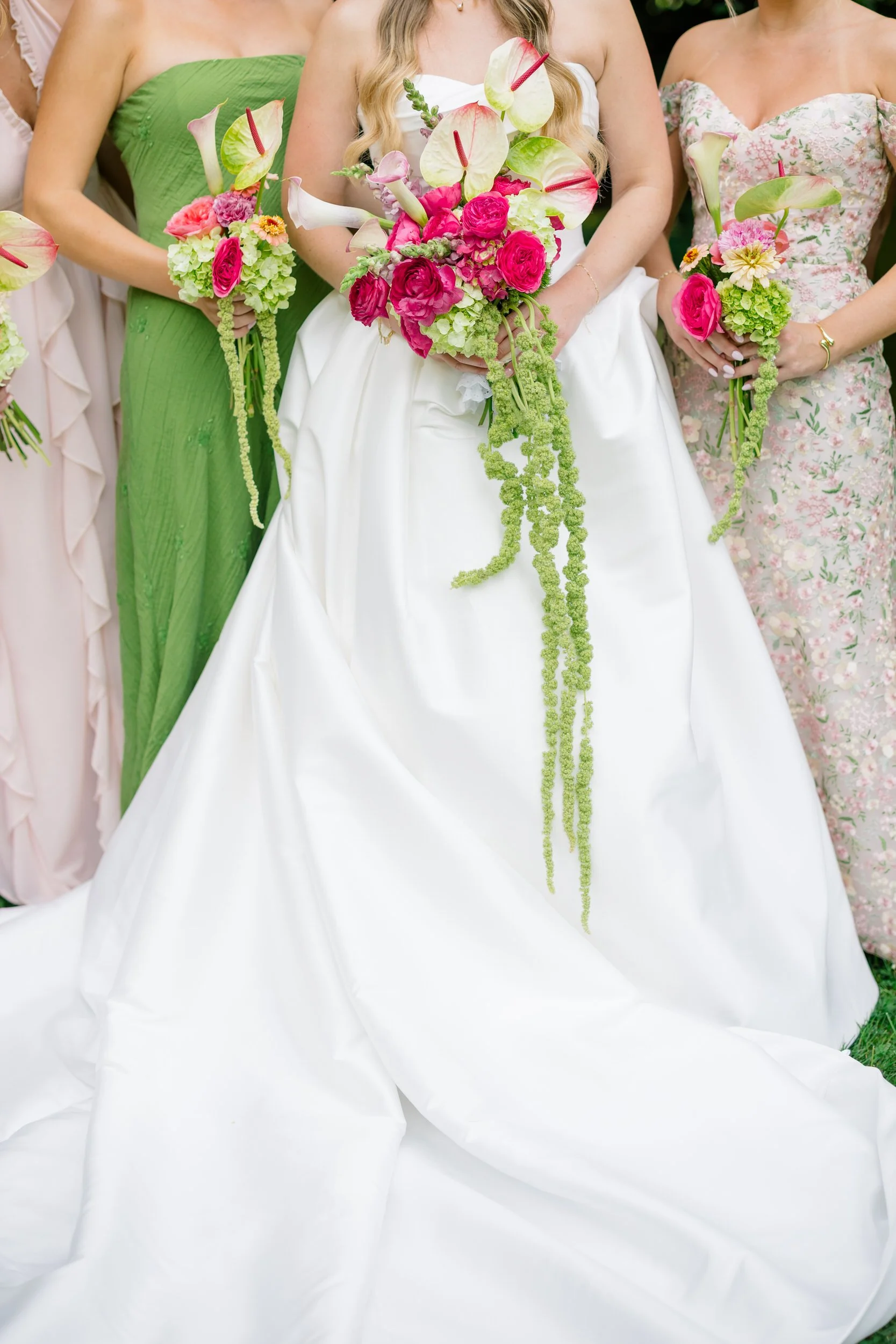Bridesmaids in patterned dresses during a garden wedding celebration