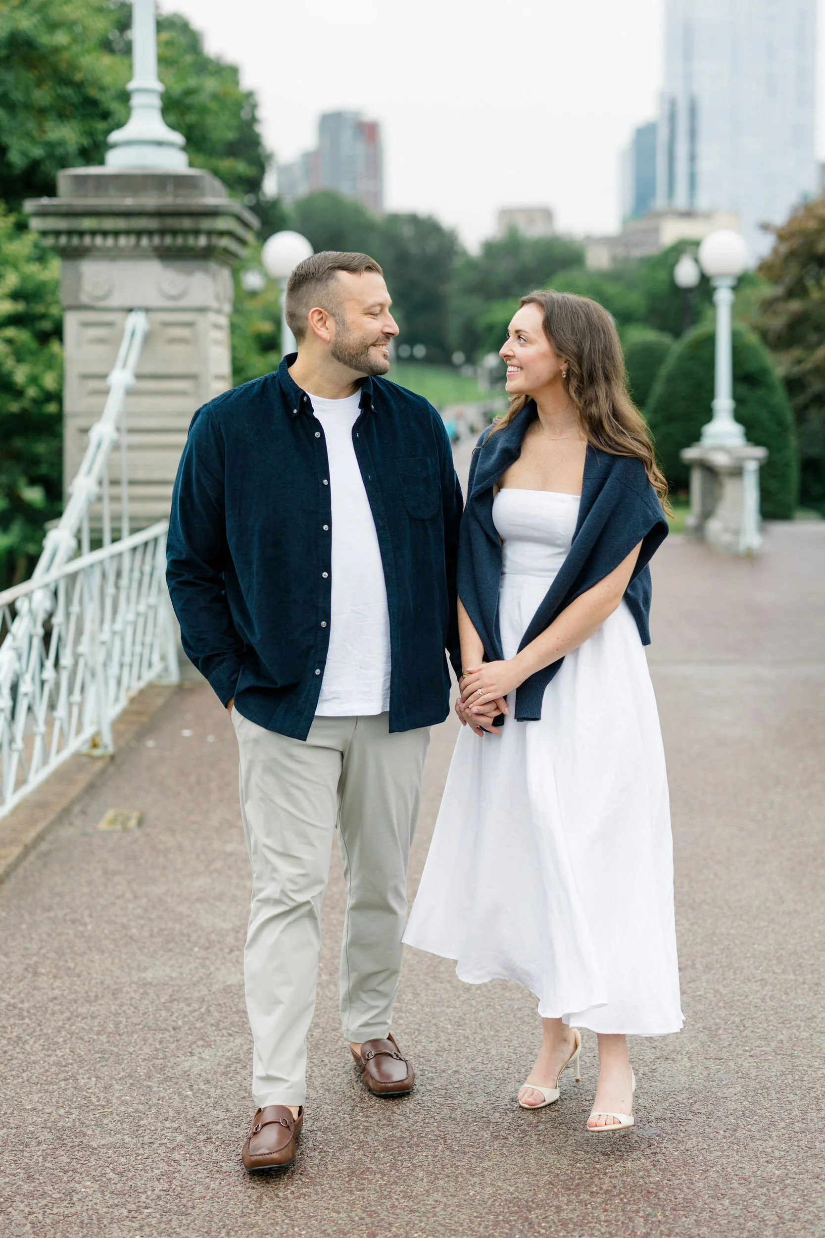 Couple walking through the Boston Public Garden during an engagement session