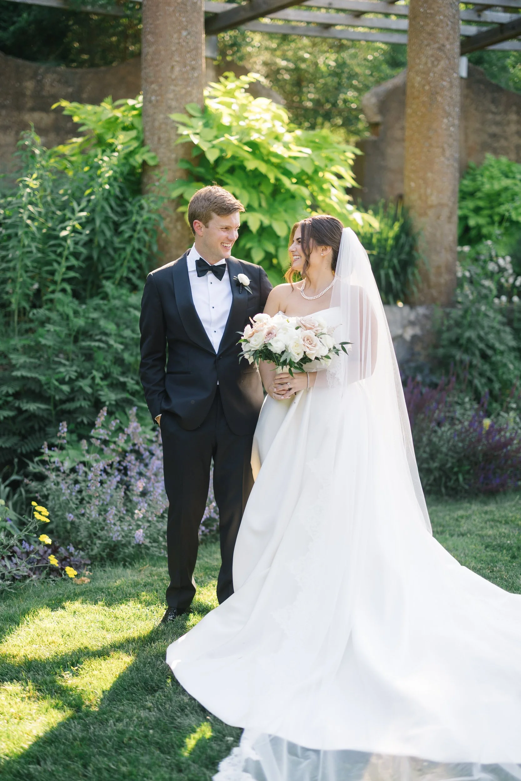 Candid couple’s portraits captured in soft natural light throughout the Crane Estate estate grounds.
