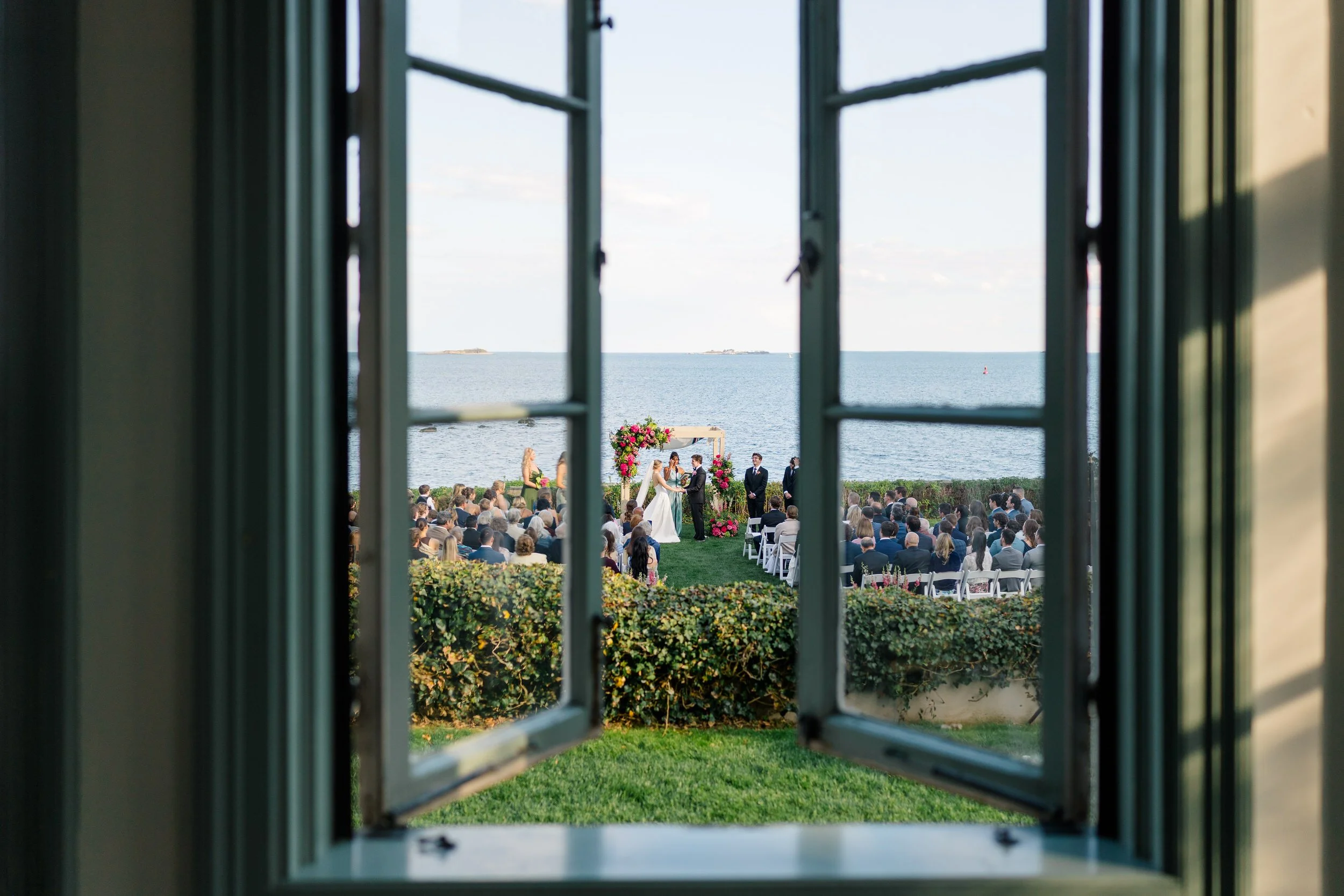 Bride and groom exchanging vows at waterfront Massachusetts wedding venue