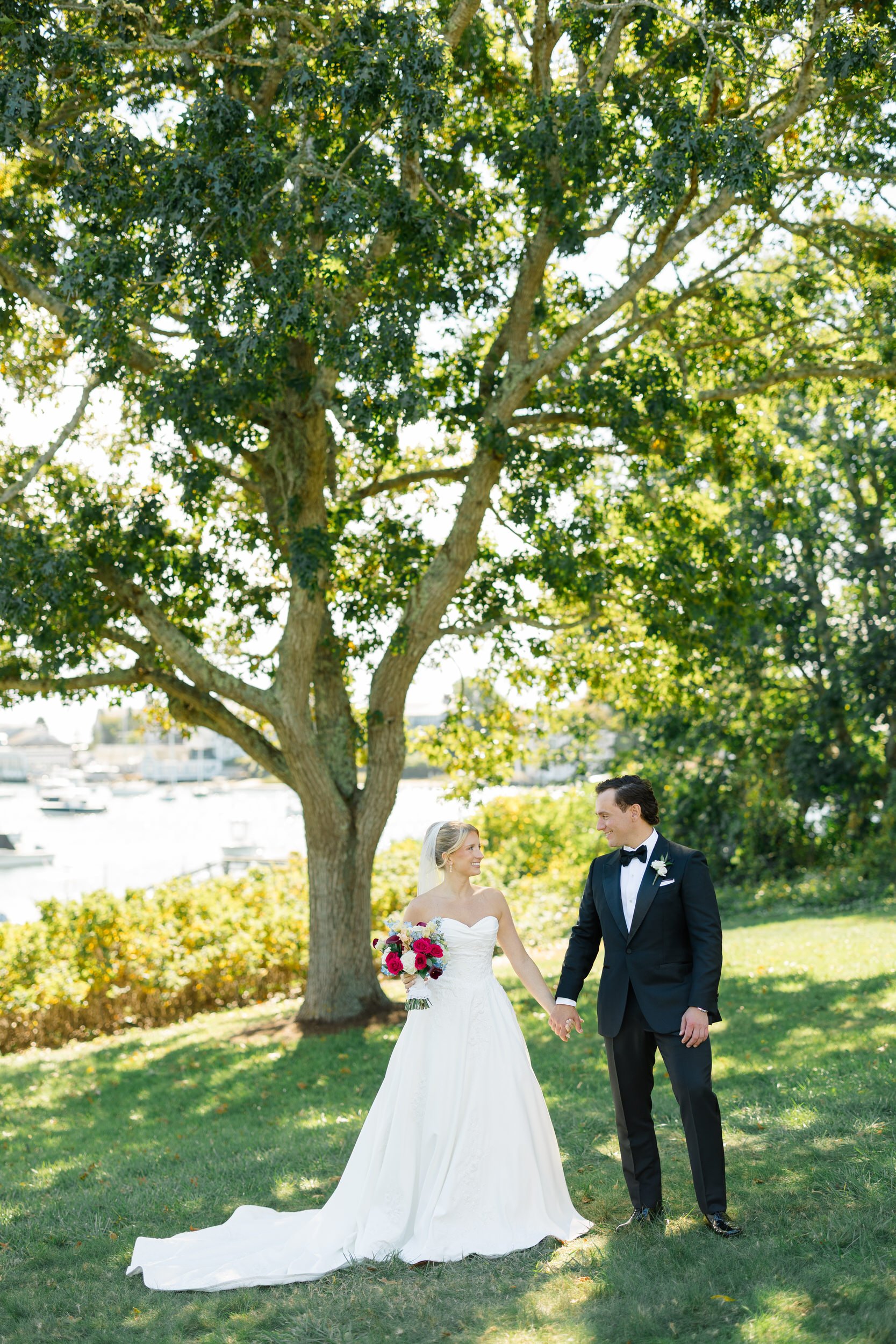 Bride and groom photographed beside the water at their Cape Cod wedding.