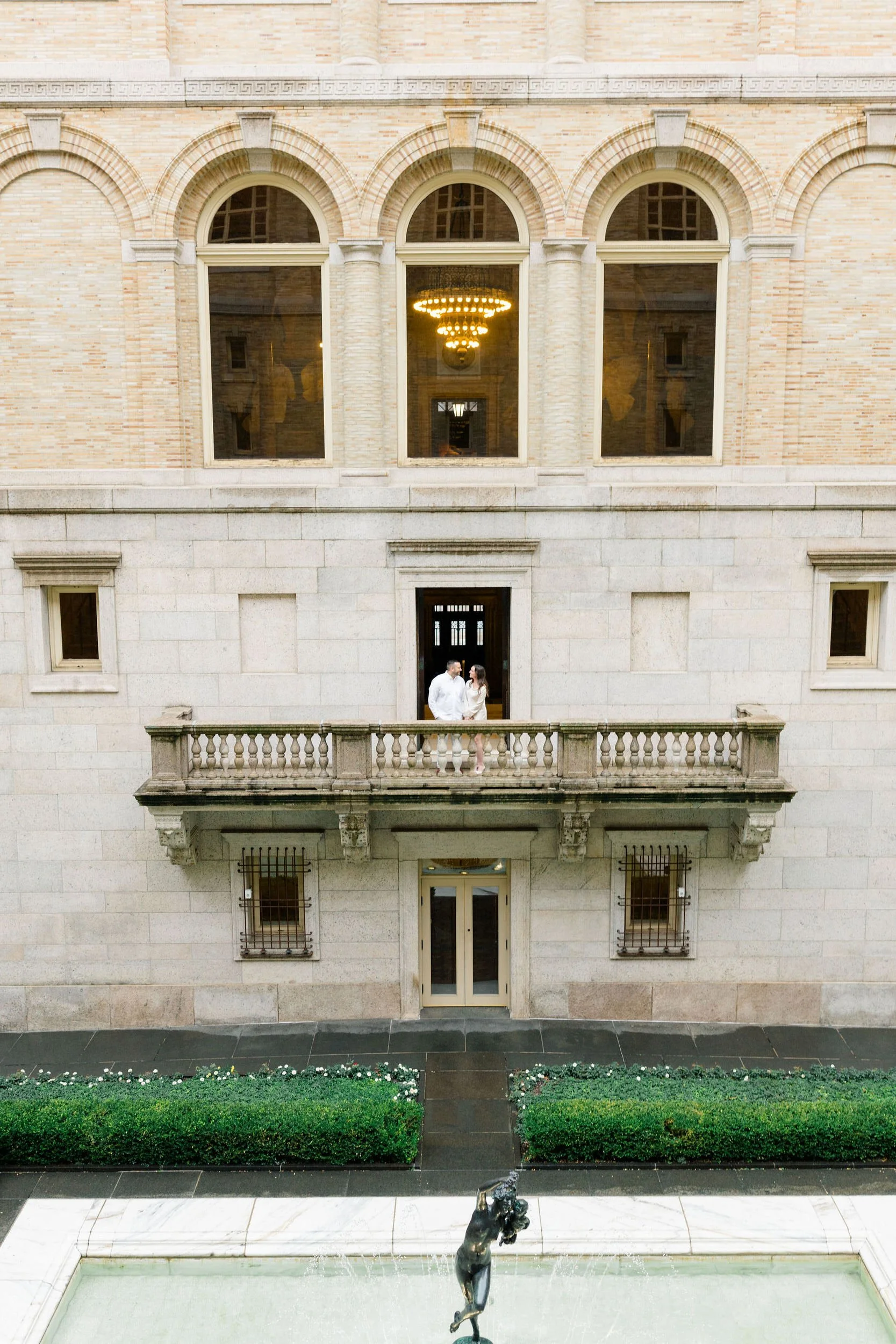 Couple embracing during an engagement photoshoot at the Boston Public Library