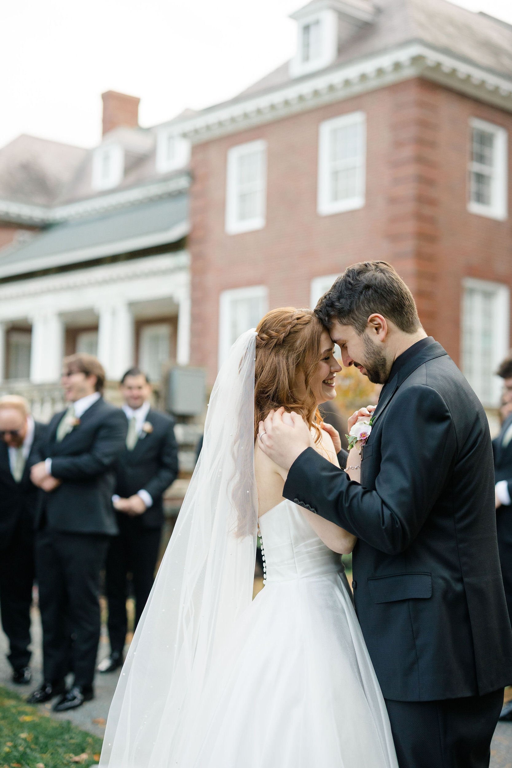 Outdoor wedding ceremony at Elm Bank featuring seasonal fall colors and garden scenery.