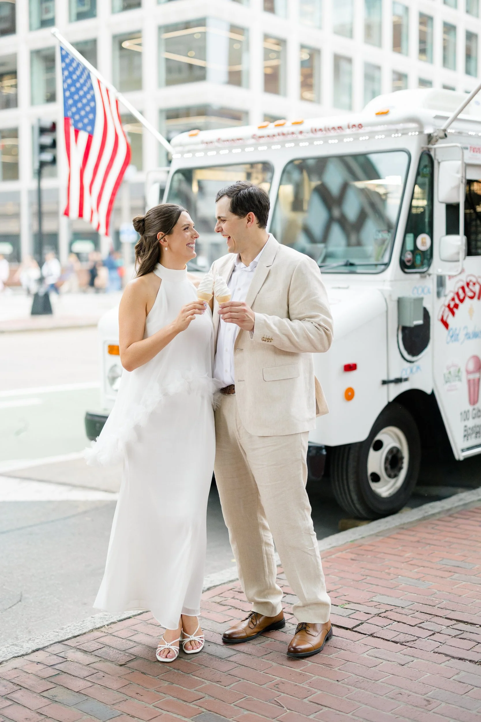 Couple enjoying ice cream from Frosty's truck after a Boston engagement session.