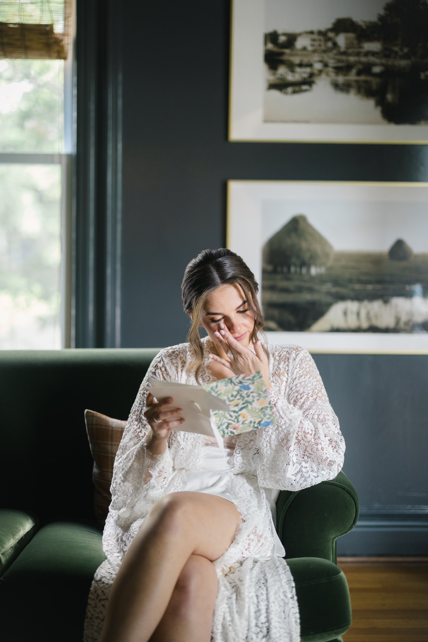 The bride reading a heartfelt letter on the morning of her wedding before traveling to Castle Hill on the Crane Estate.