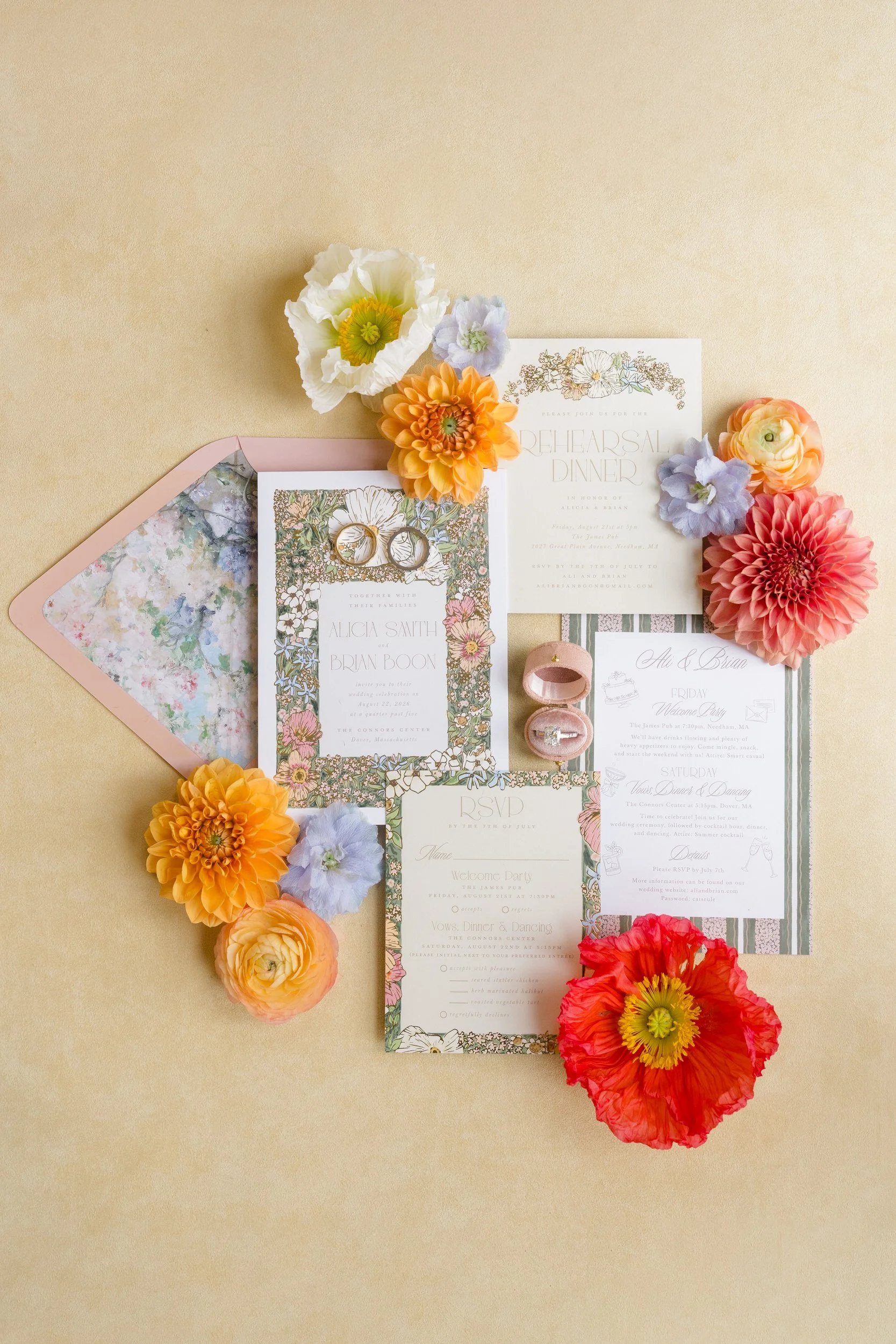 Colorful bridal flat lay featuring floral stationery and bright garden-inspired wedding details.