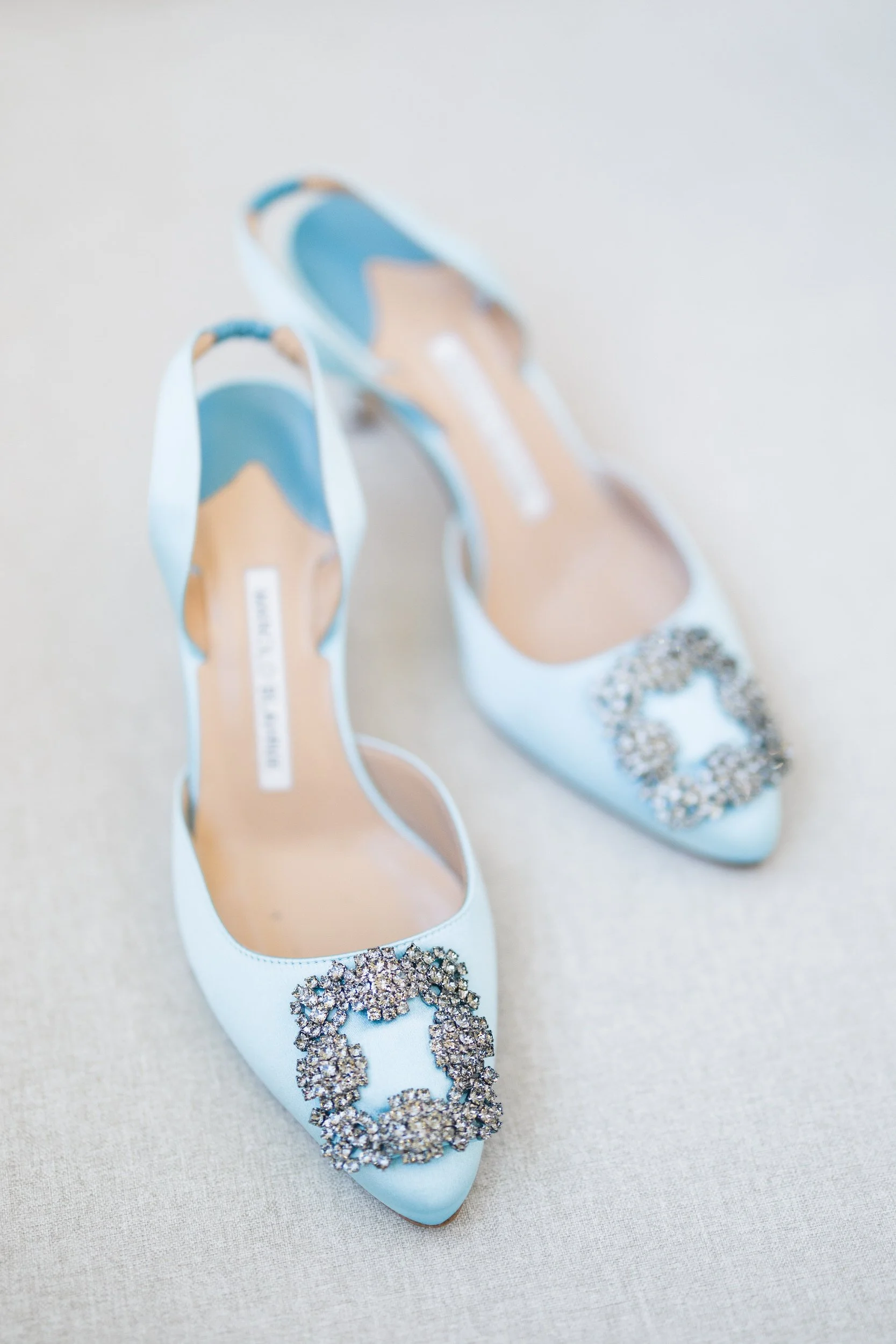 Bridal shoes, jewelry, and accessories styled in a Boston Harbor Hotel suite