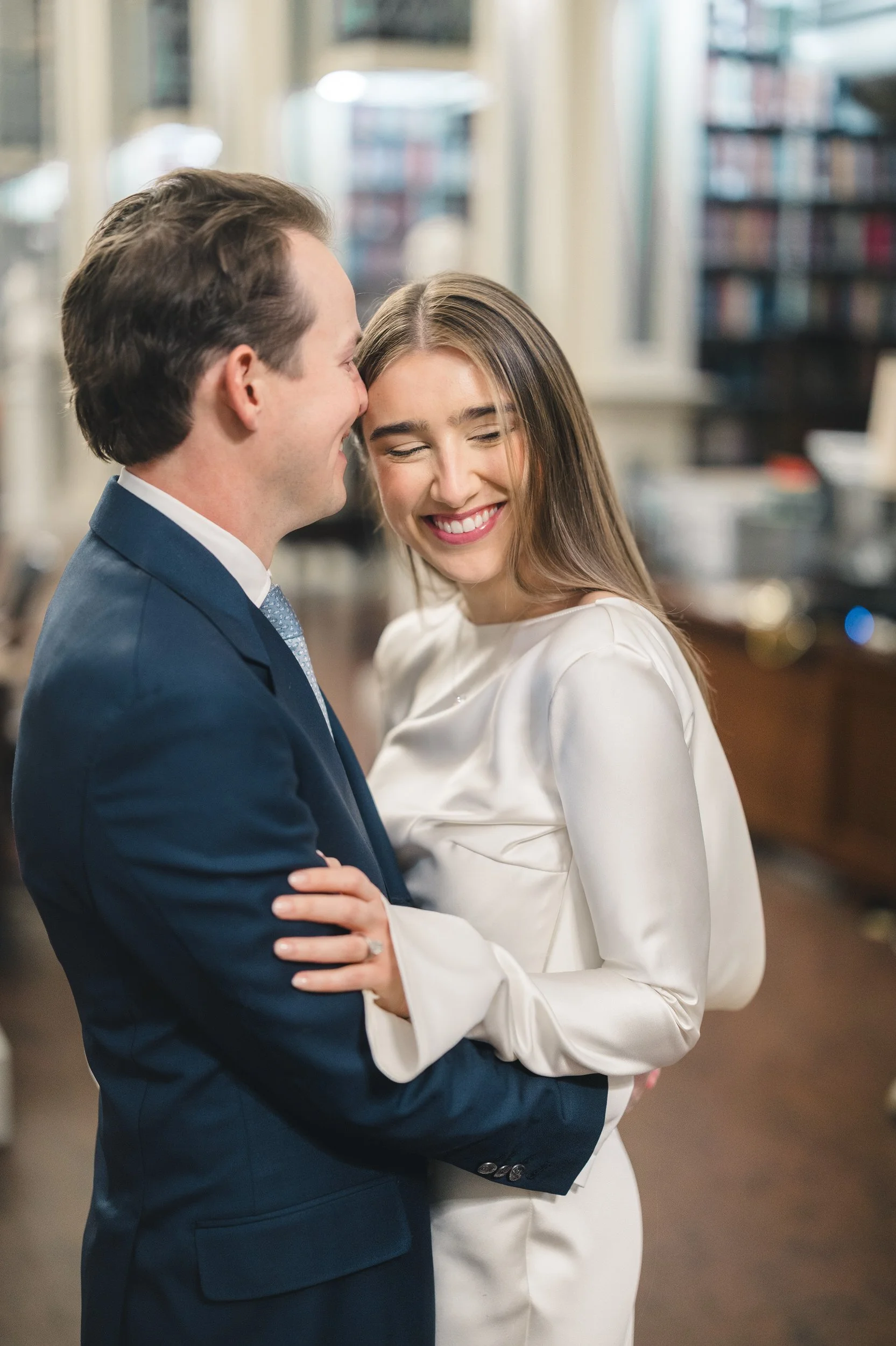 Couple portraits inside the Boston Athenaeum surrounded by classic books