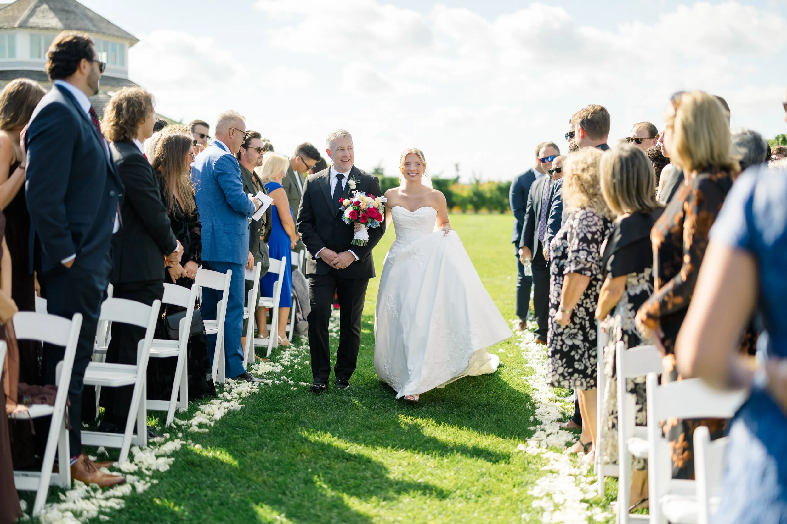 Bride walking down the aisle at the Dune lawn ceremony space.
