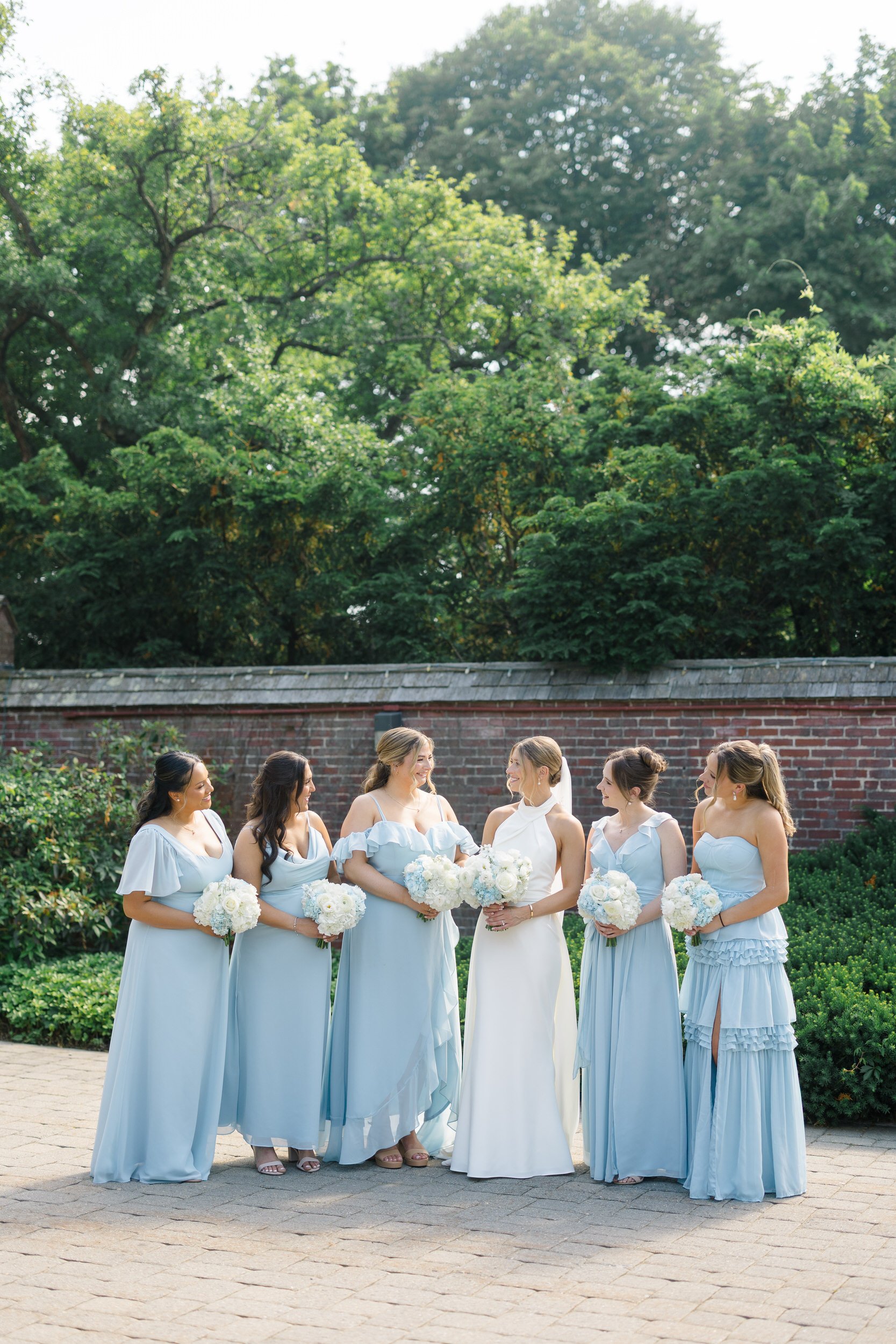 Wedding party portraits featuring summer sunshine and coastal views.