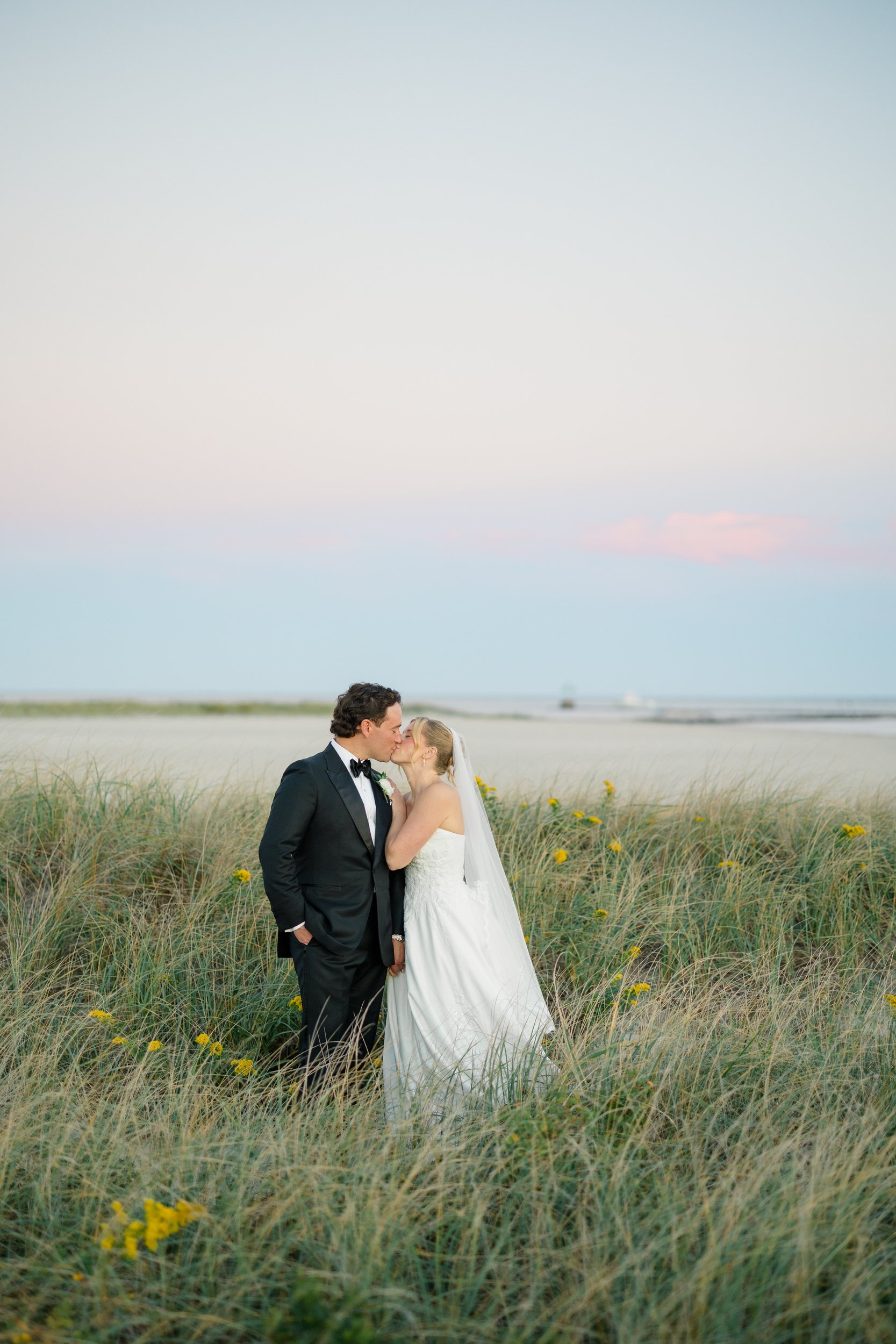 Bride and groom sharing a moment by the water during their Cape Cod wedding.