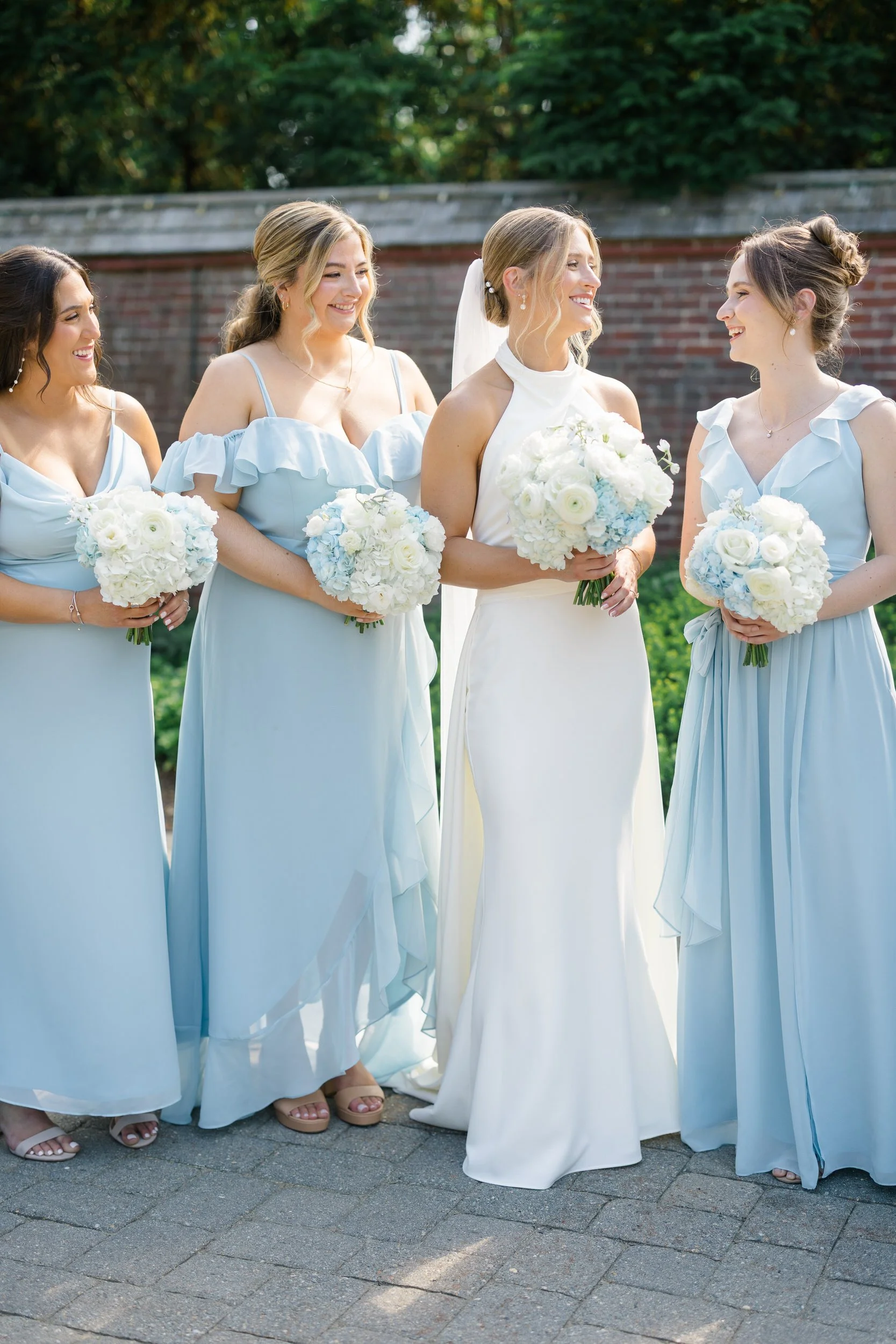 Wedding party portraits featuring summer sunshine and coastal views.