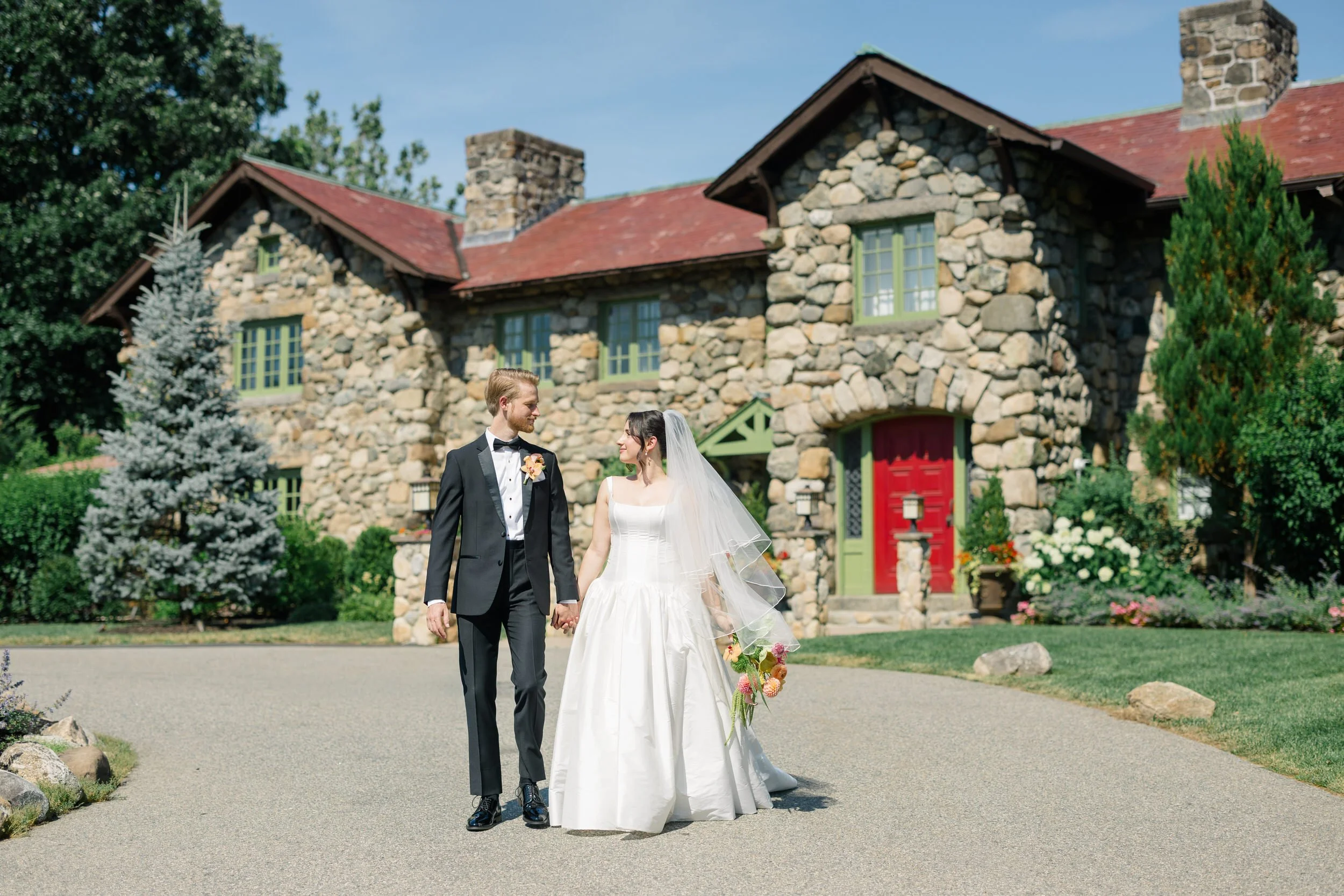 Editorial wedding portraits of bride in basque waist gown and groom in black suit at estate venue