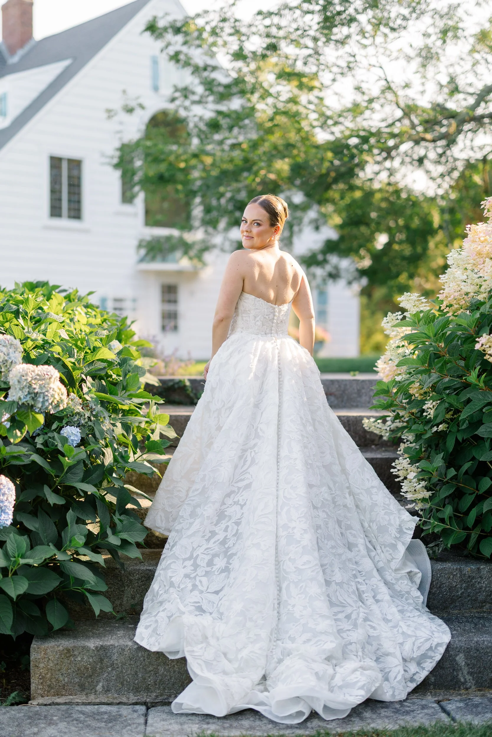 Romantic bridal portrait surrounded by hydrangeas during a luxury Cape Cod private estate wedding.