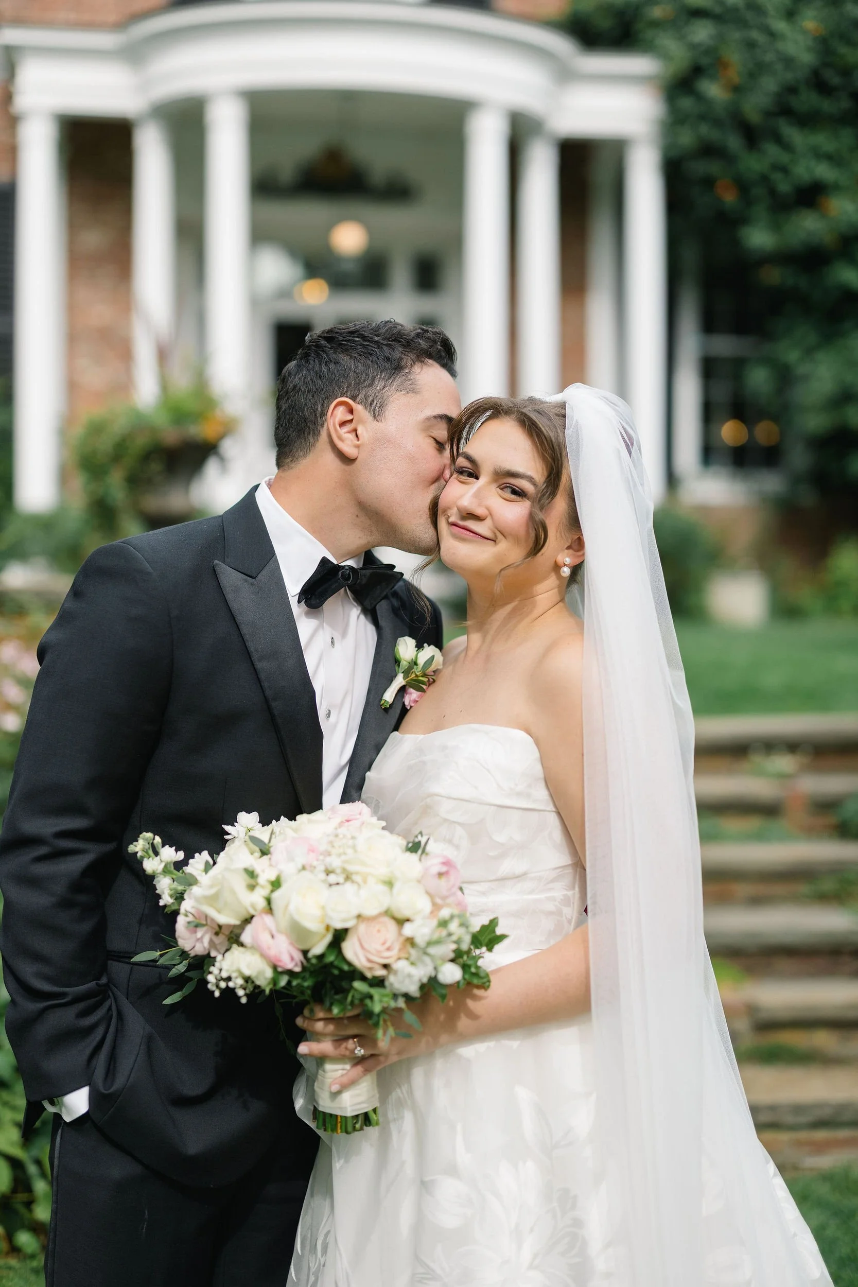 Wedding couple photographed against the architecture of the Long Hill estate.