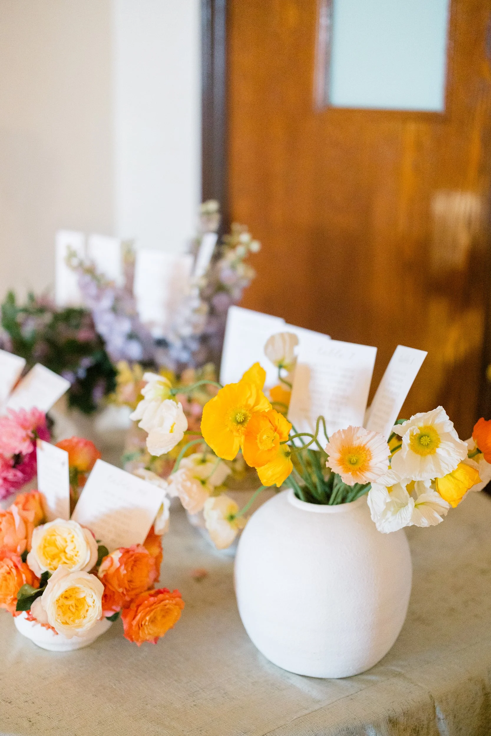 Vibrant cocktail hour details featuring seasonal dahlias, poppies, and English roses.
