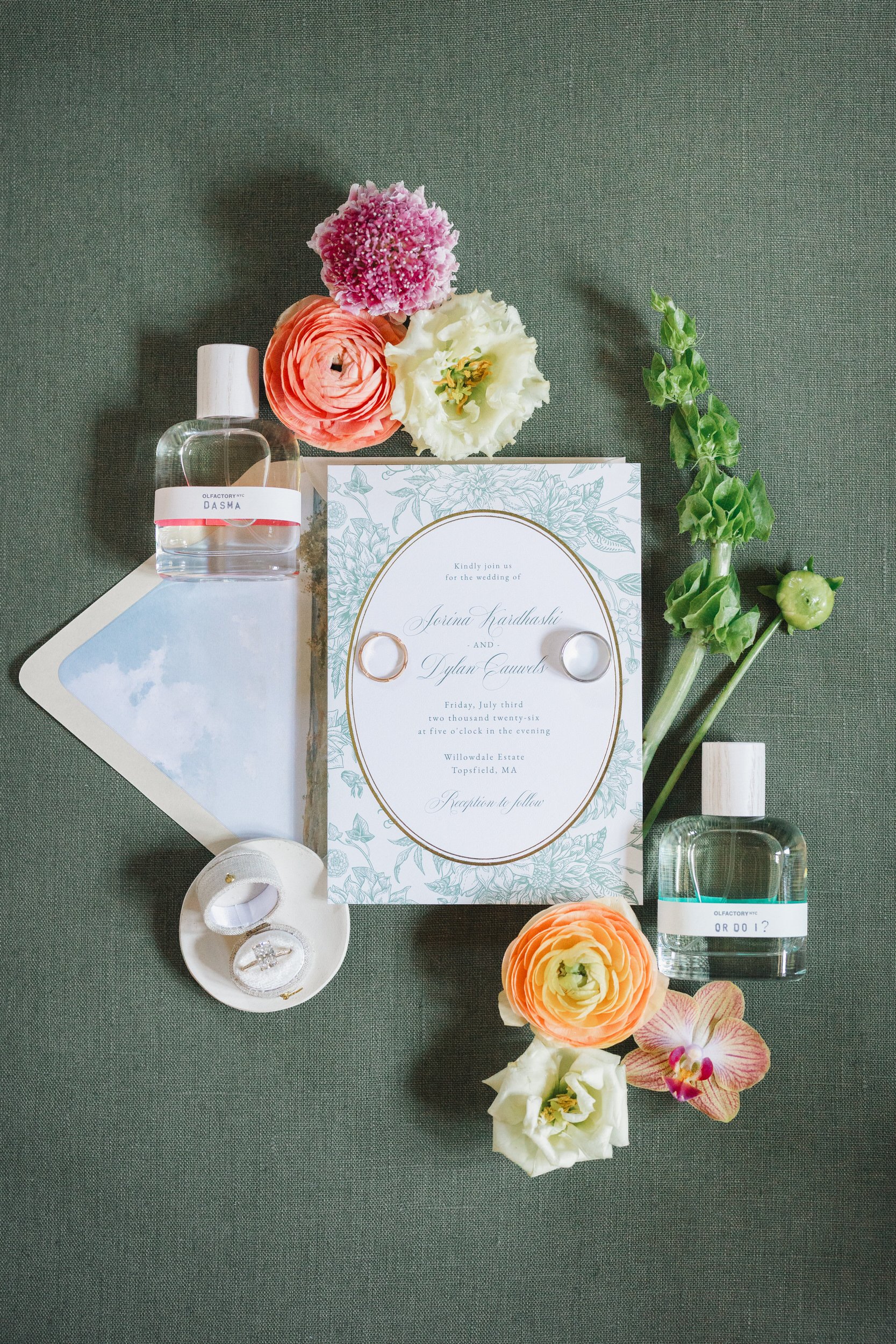 Flat lay of green wedding details at Willowdale Estate featuring tropical florals and bridal accessories