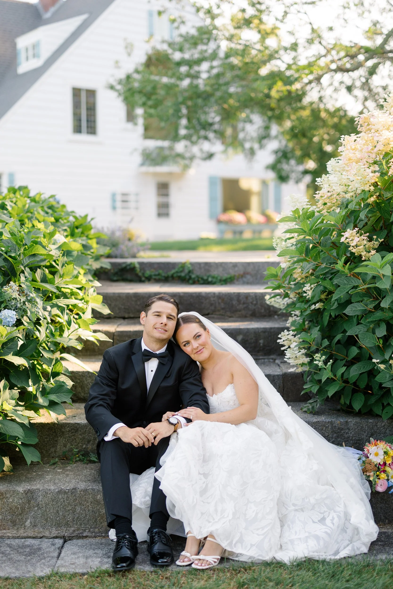 Romantic couple portraits among blue hydrangeas at a waterfront private estate on Cape Cod.