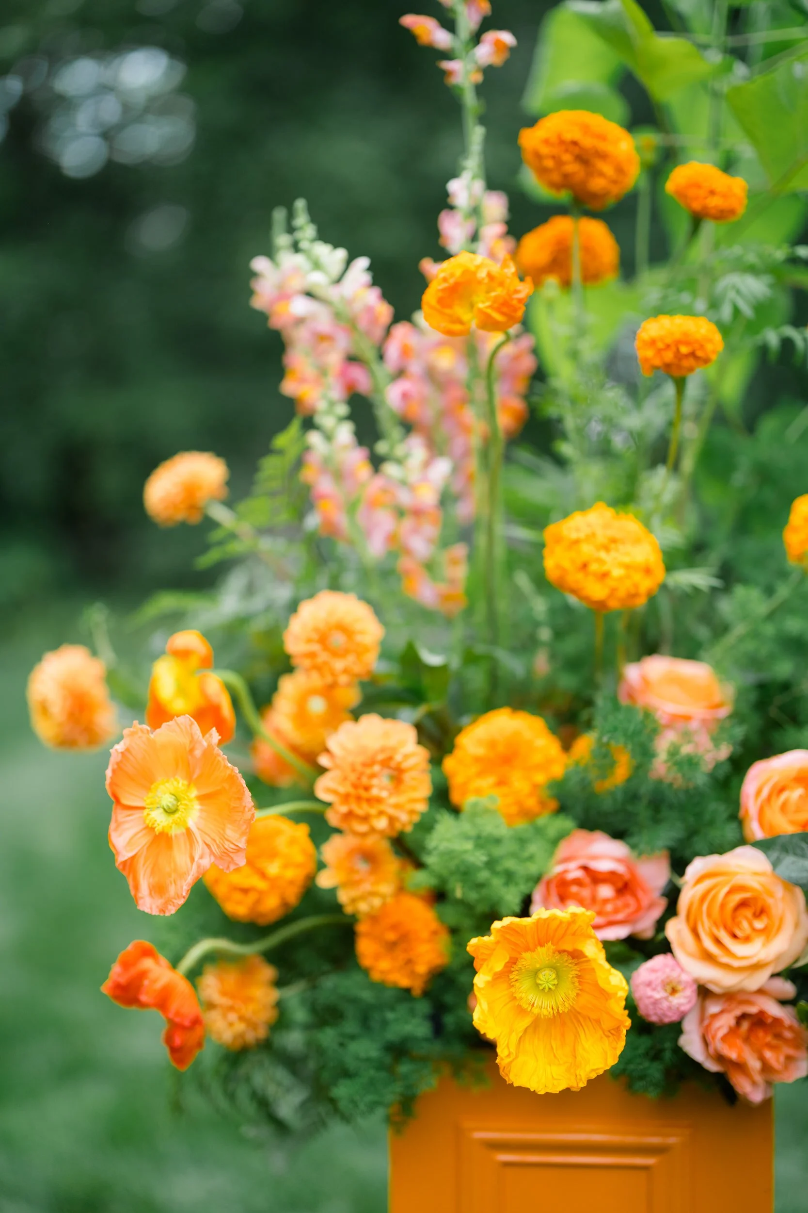Whimsical garden-inspired ceremony decorated with vibrant seasonal flowers at the Connors Center.