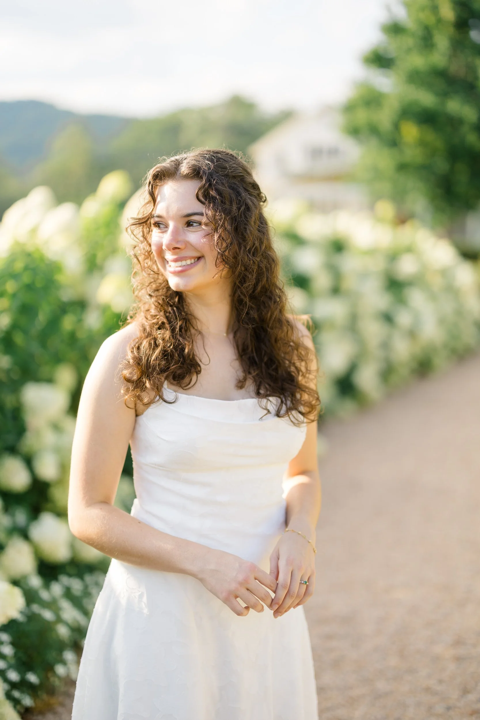 Romantic engagement portraits among the white hydrangeas at Pippin Hill