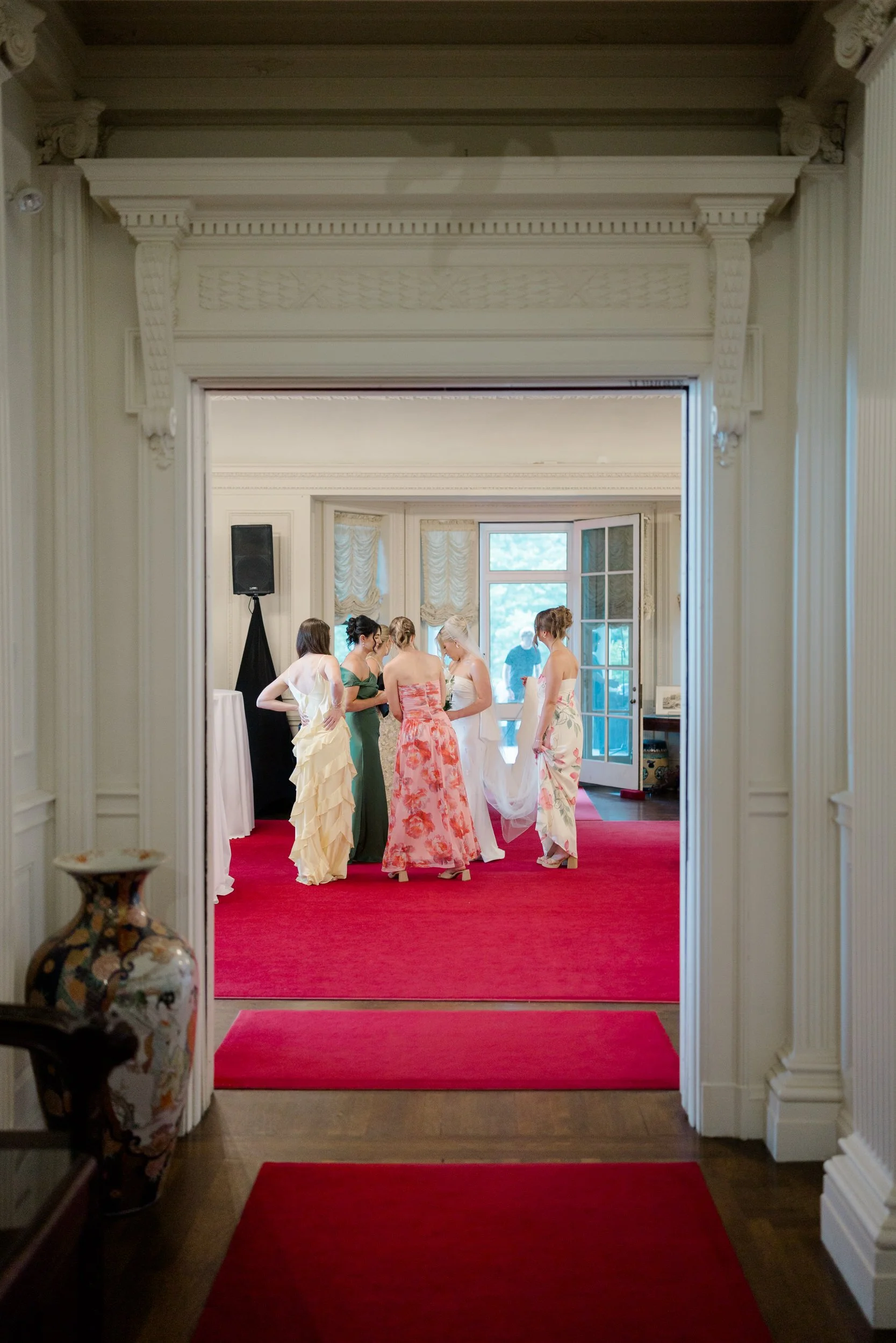 Documentary-style photograph of the bride getting ready with her bridesmaids before the ceremony.