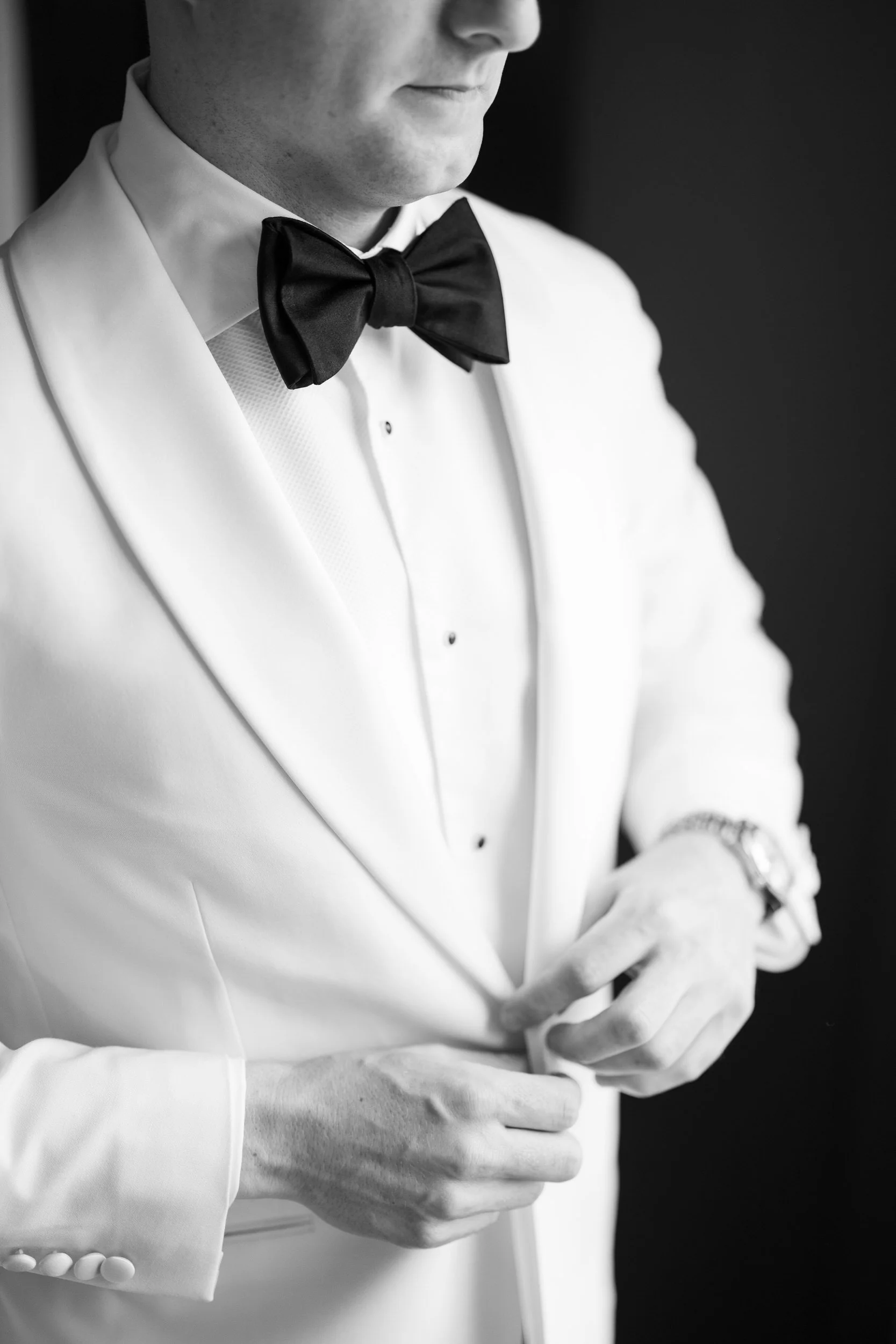 Groom adjusting his suit before the ceremony at Blithewold Mansion & Gardens.