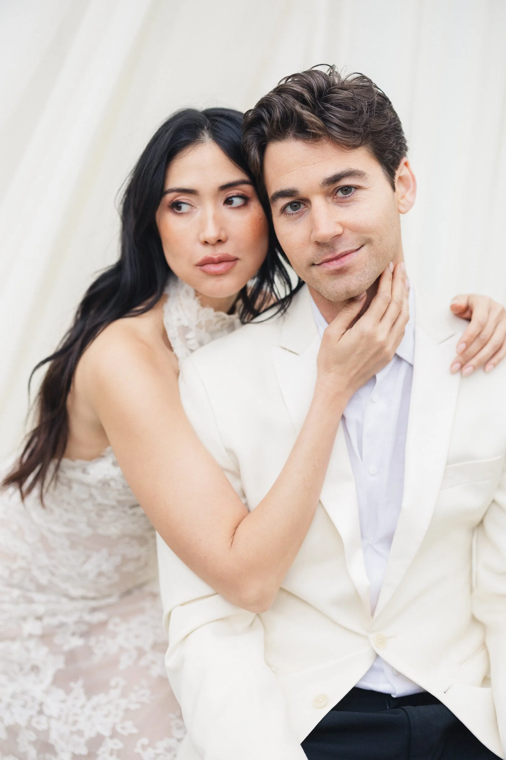 Romantic couple portraits beneath flowing white drapery at Charleston wedding venue