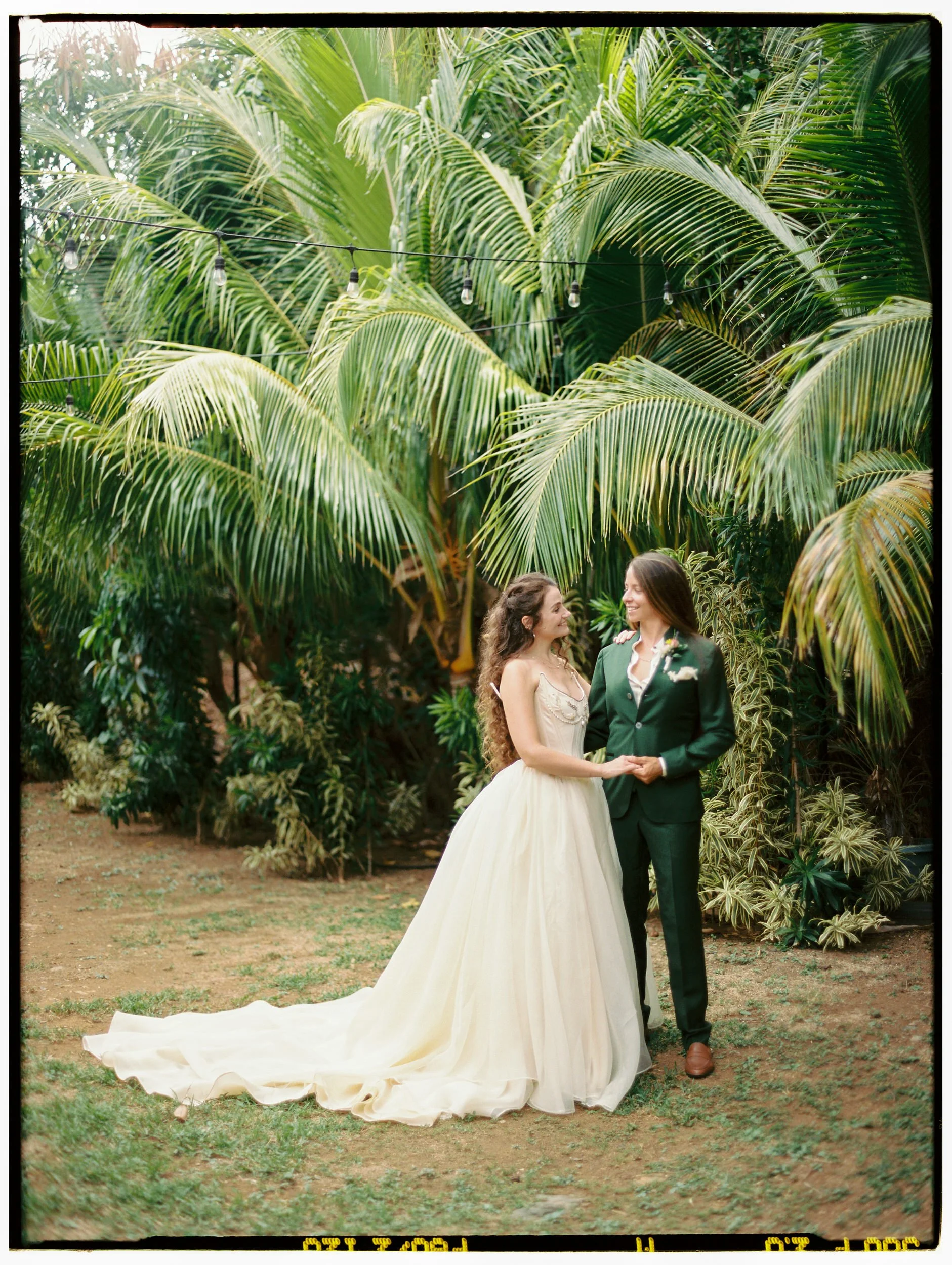 Queer destination wedding photography in a secluded tropical banana grove.