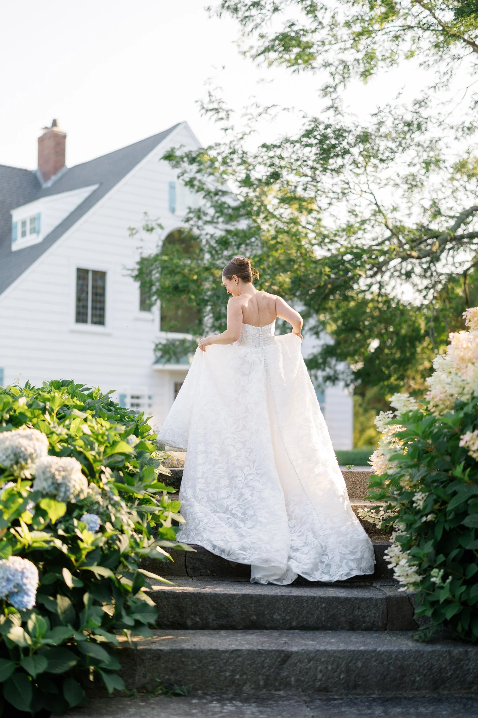 Romantic bridal portrait surrounded by hydrangeas during a luxury Cape Cod private estate wedding.