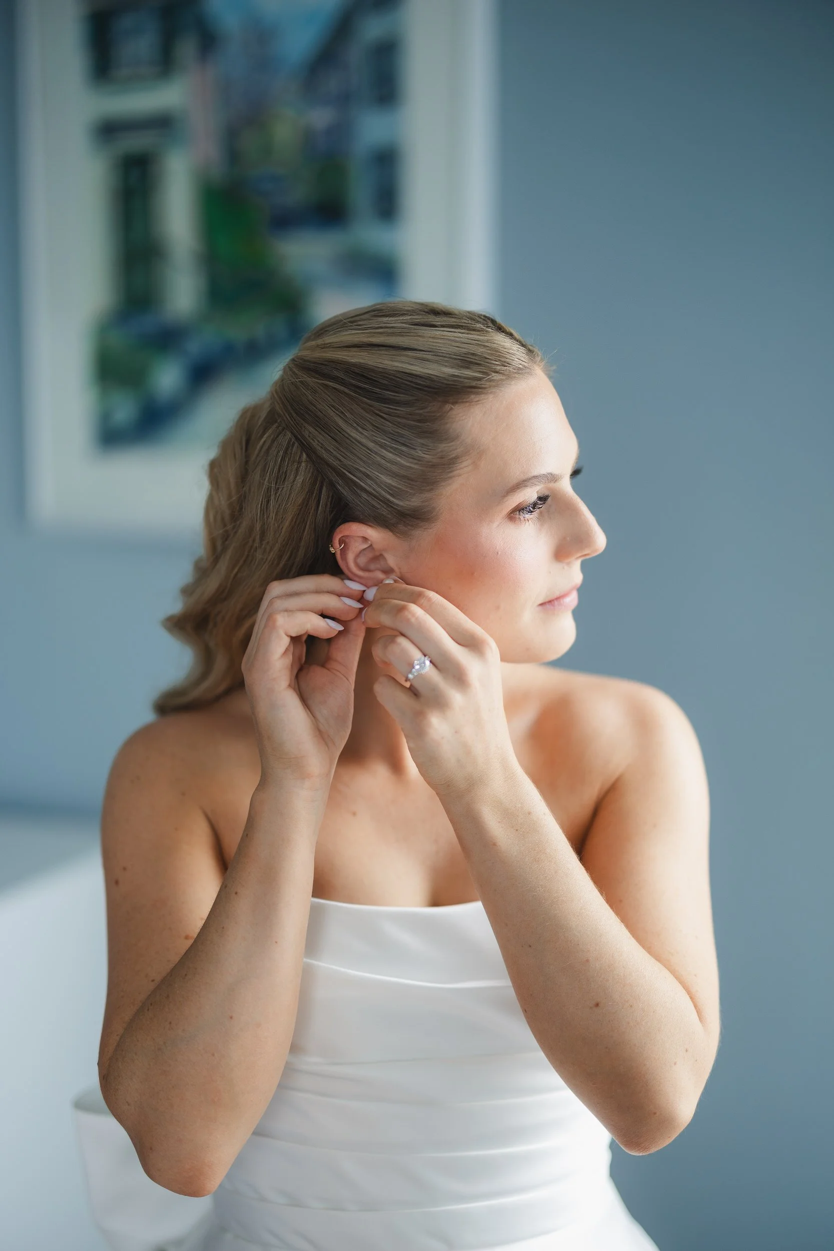 The bride prepares for her wedding day at Corinthian Yacht Club with coastal New England views nearby.