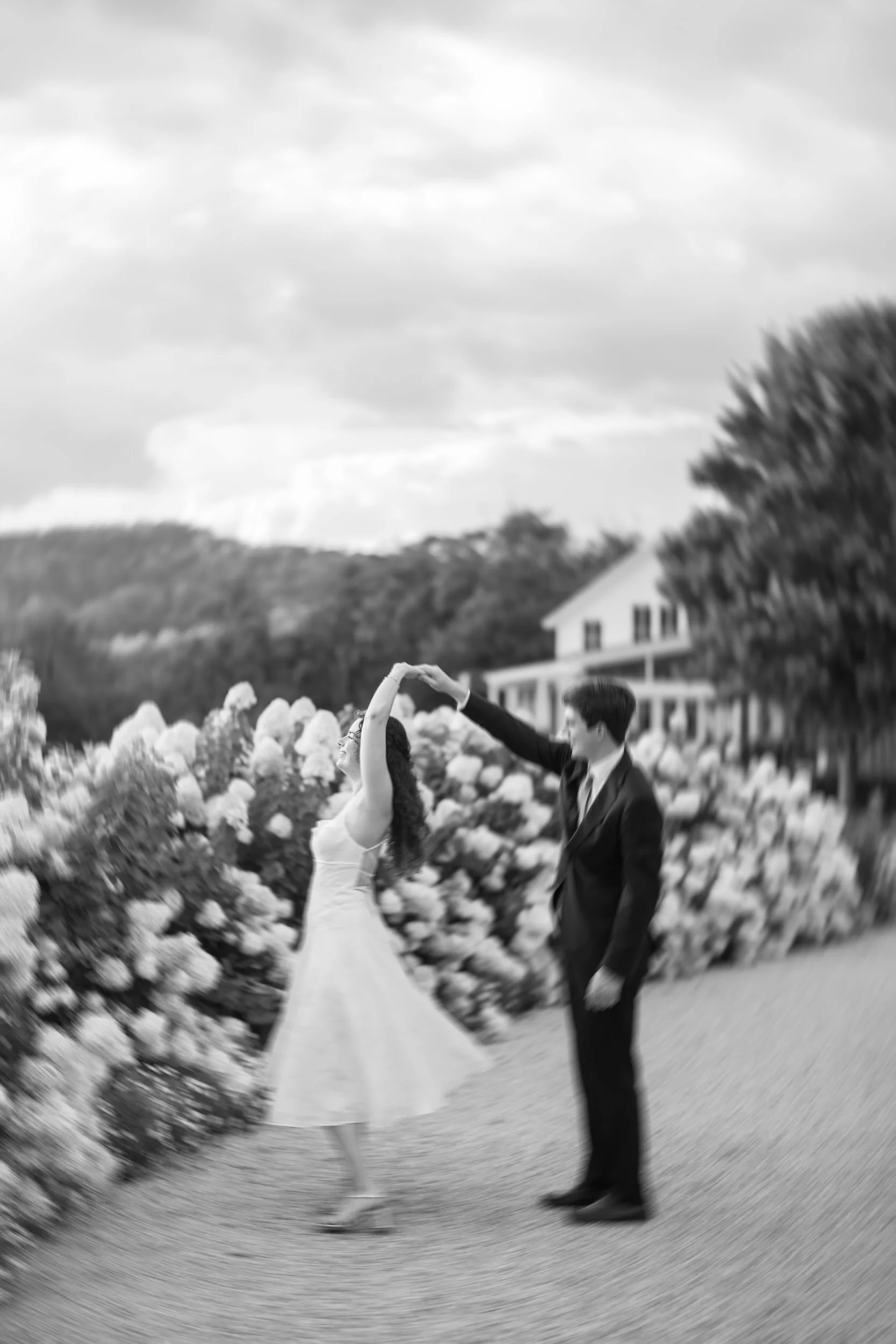 Couple walking through the white hydrangea garden during their Pippin Hill engagement session