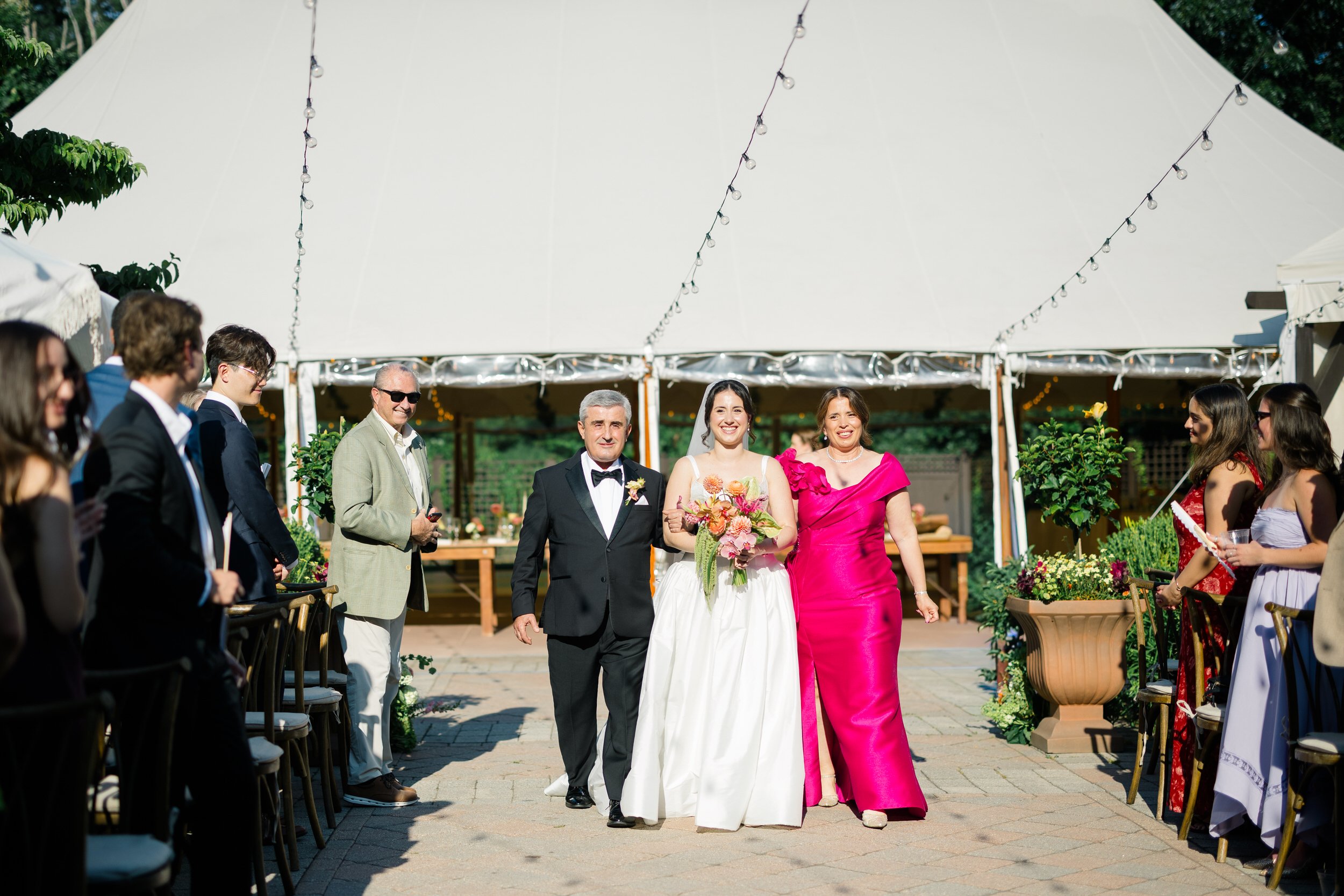 Couple during outdoor ceremony at Willowdale Estate surrounded by vibrant floral design