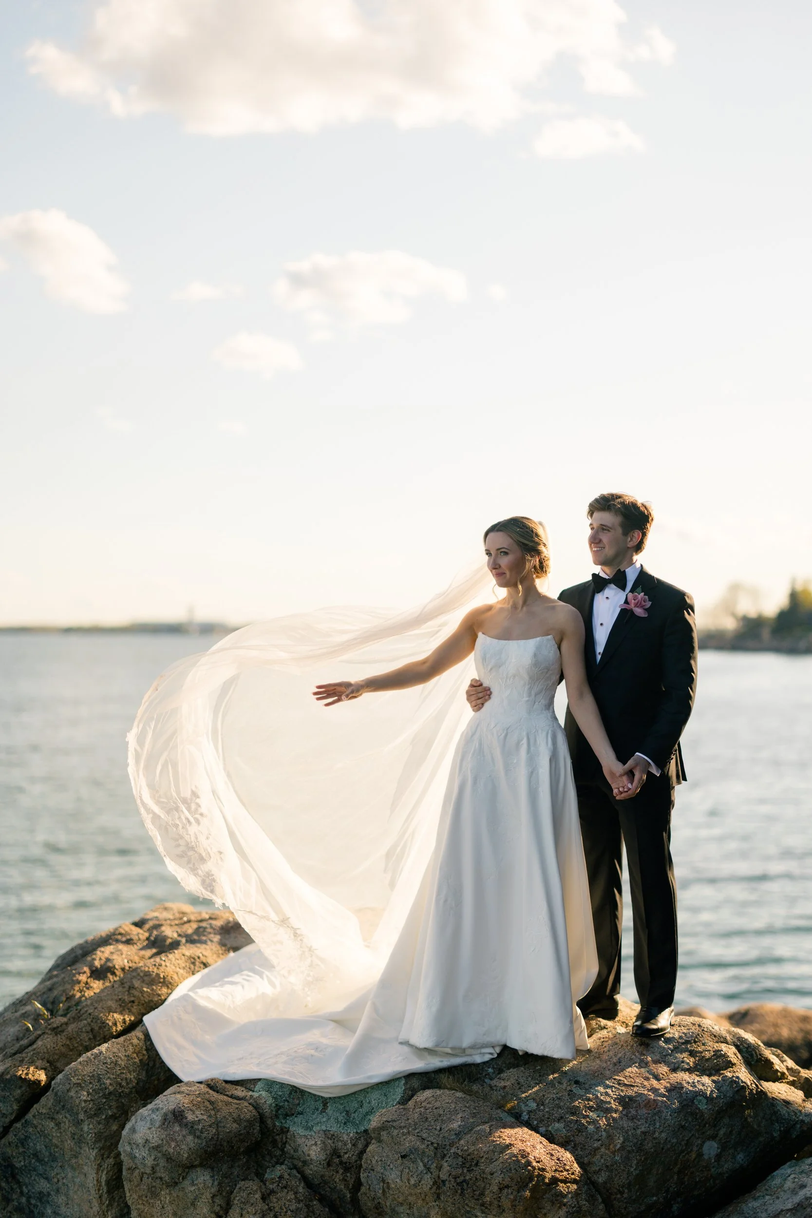 Romantic golden hour wedding portraits on the rocky coastline at Misselwood Estate