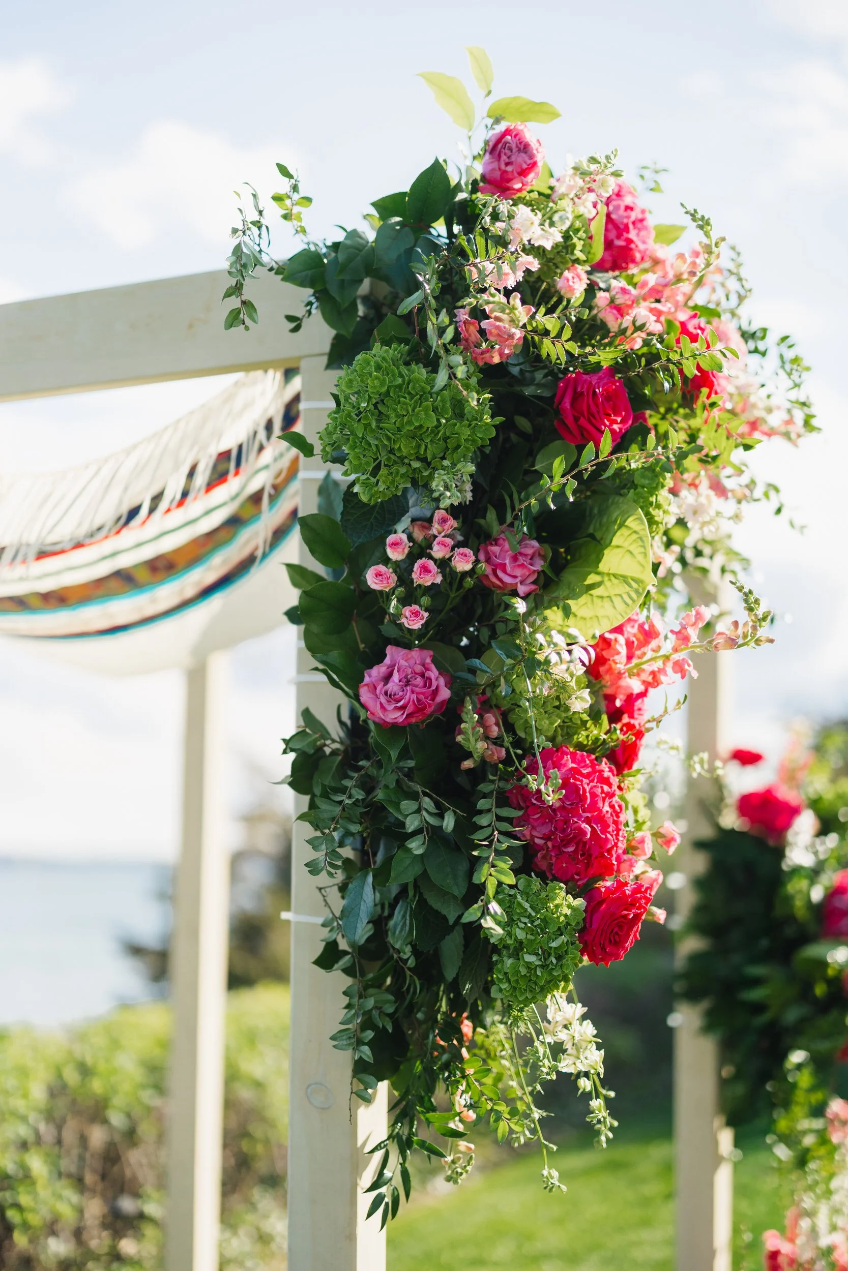 Modern wedding ceremony design with mauve, pink, and green flowers