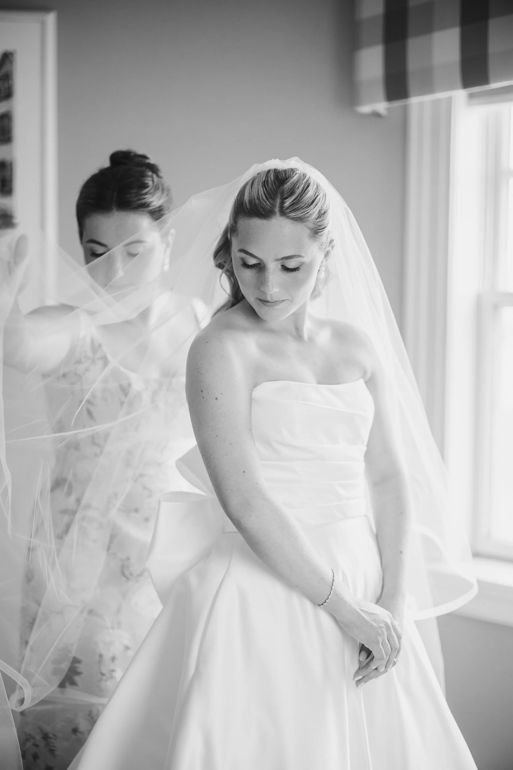 The bride prepares for her wedding day at Corinthian Yacht Club with coastal New England views nearby.