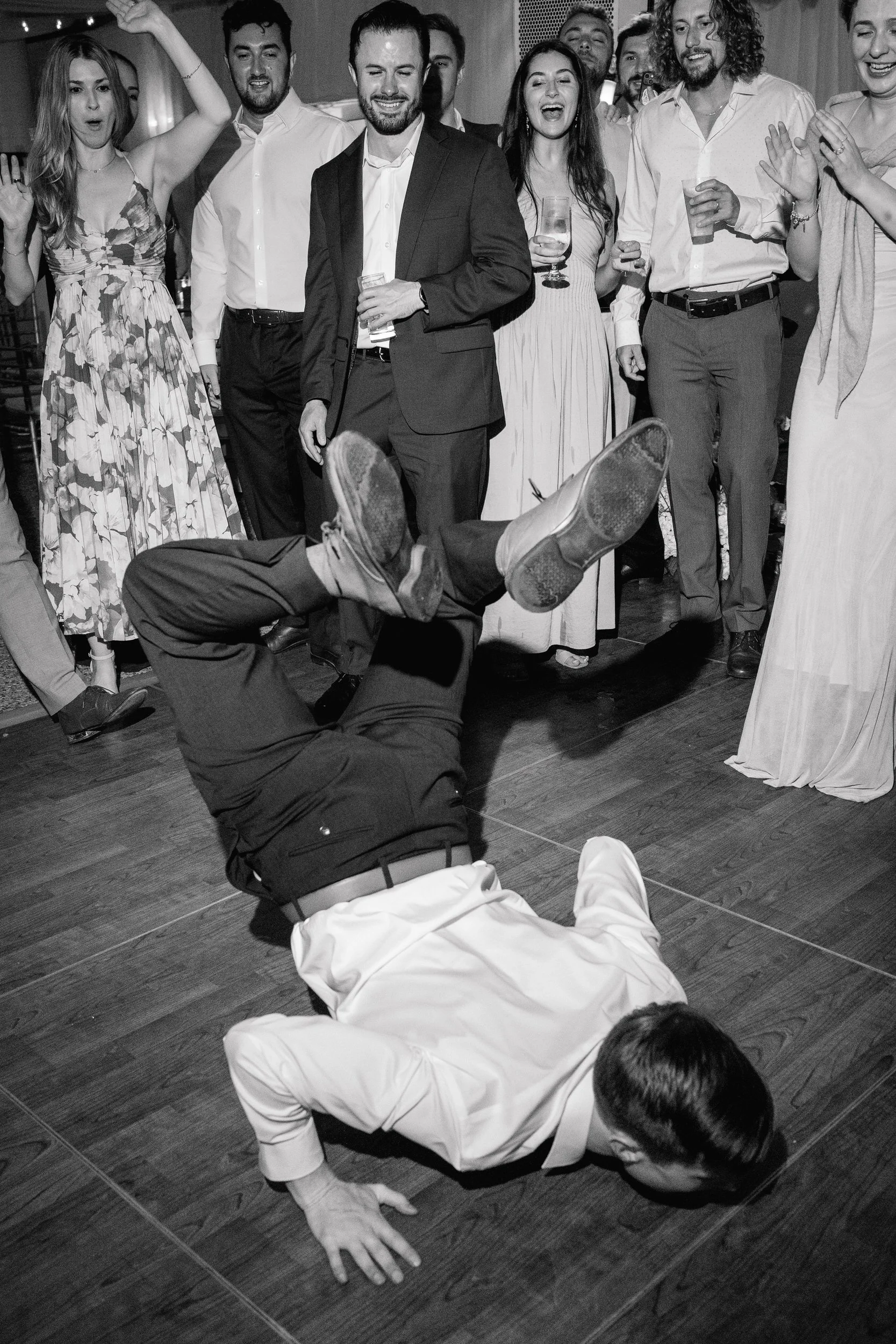 Packed dance floor during an elegant coastal wedding celebration.