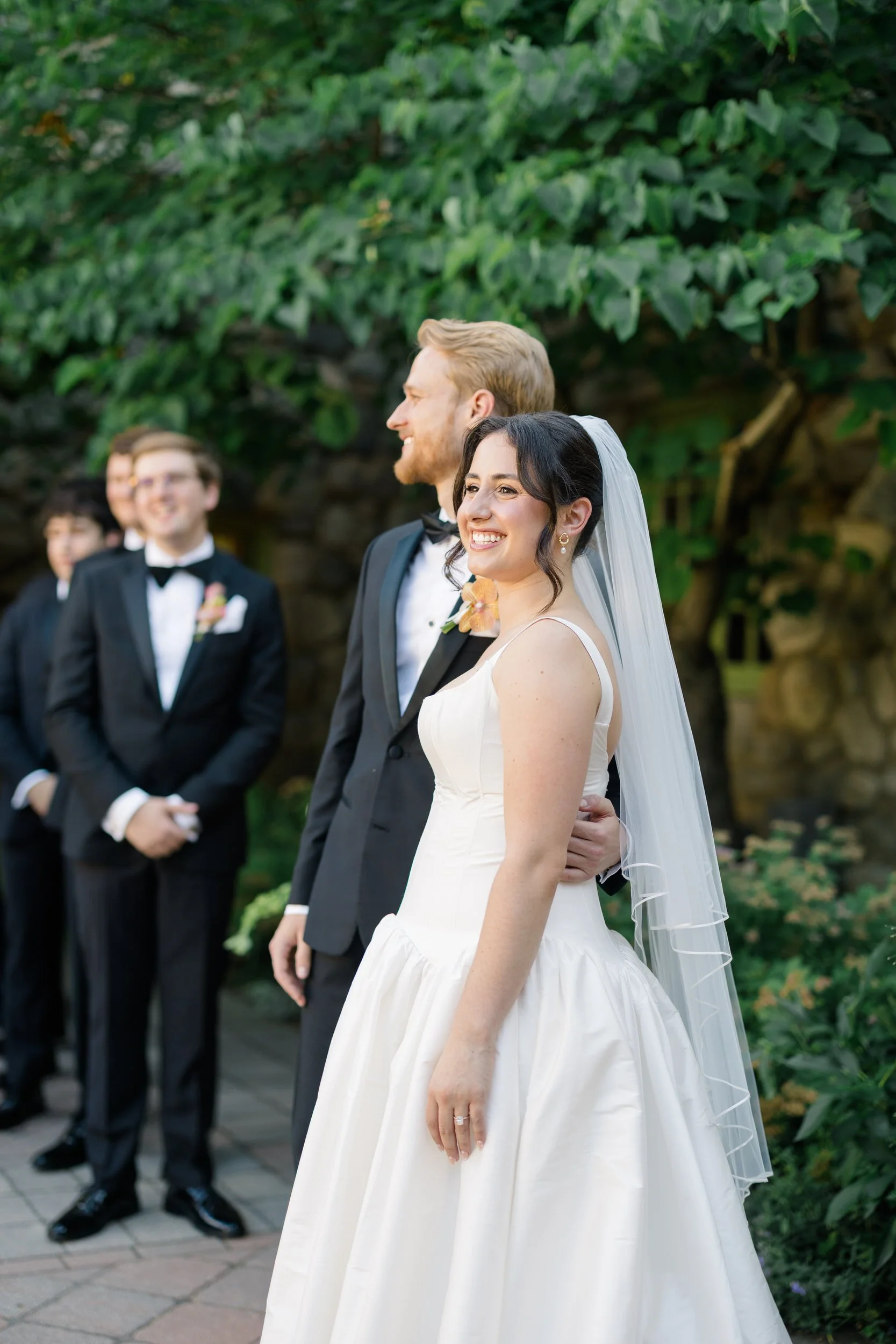 Couple during outdoor ceremony at Willowdale Estate surrounded by vibrant floral design