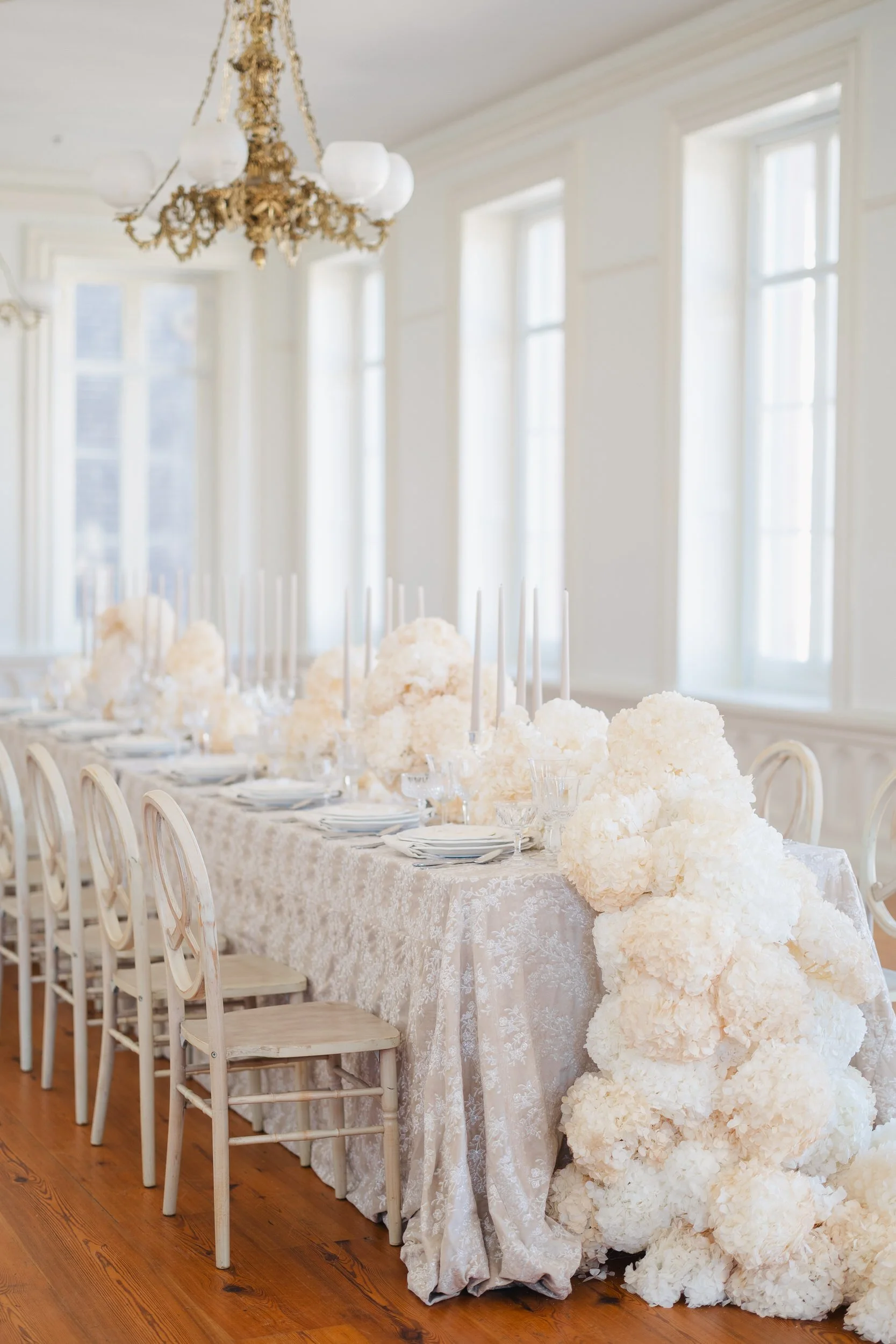 Elegant neutral wedding reception tables at Brasserie La Banque in downtown Charleston, South Carolina.